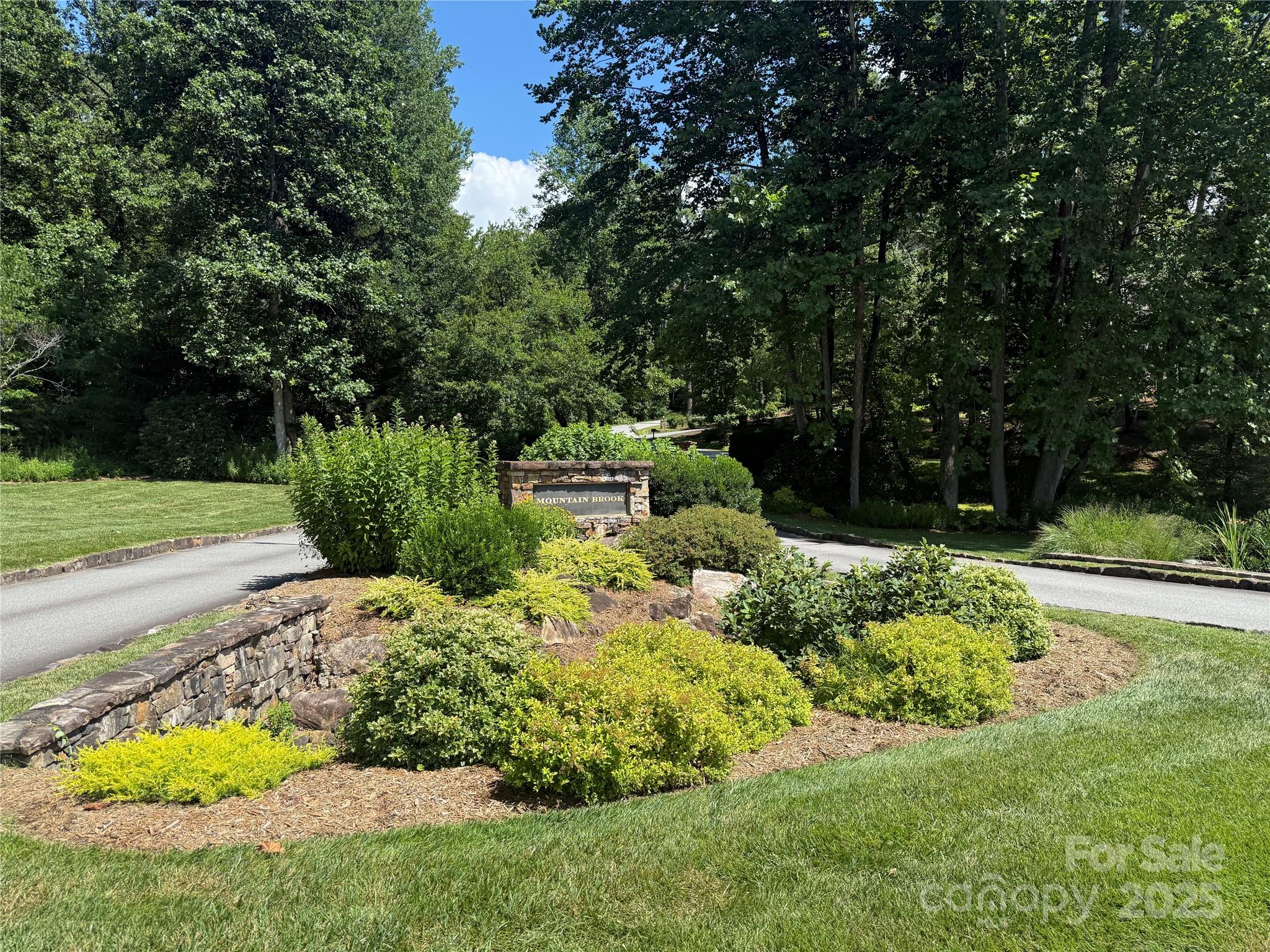 Exceptional 1.03 acre level buildable lot in the tranquil Mountain Brook subdivision of Brevard. This easily accessible lot offers the perfect blend of natural beauty, convenience, and exclusivity that speaks to your soul while eliminating otherwise costly site preparation, making it ideal for creating your custom mountain retreat. Utilities are  underground. Just 2.5 miles from downtown Brevard, Mountain Brook offers the serenity of mountain living while maintaining easy access to urban amenities including Brevard Health and Racquet Club just up the road. Mountain Brook is one of Brevard's loveliest residential communities featuring lush landscape and quality mountain style homes. It has been discovered!