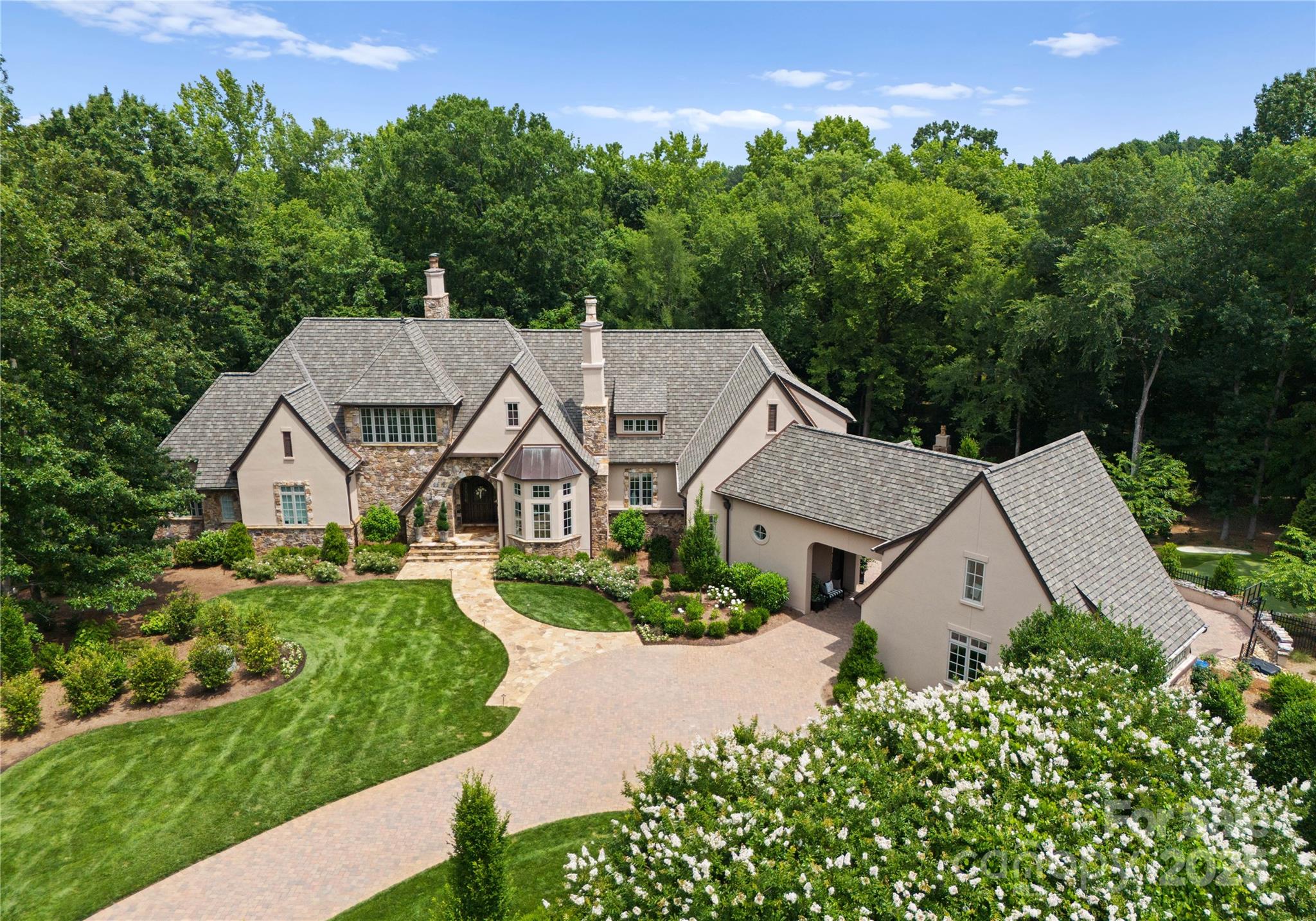 Elegantly renovated & masterfully designed, this stunning two-story basement estate is nestled on one of the largest private cul-de-sac lots in the prestigious gated Longview Country Club. Showcasing refined sophistication & timeless luxury, the home offers a grand, light-filled floor plan tailored for elevated living and entertaining. The main level impresses w/a show-stopping gourmet kitchen w/ quartzite countertops, custom cabinets & cozy fireplace. Skylights over the breakfast nook add natural drama. Owner’s suite w/heated bathroom floors, spa-like tub & expansive walk-in closet. Upstairs, all bedrooms are en-suite. The walkout basement boasts theater room, bar, gym w/sauna & spacious family room. Enjoy the saltwater pool, putting green & stone fireplace. 2nd living quarters w/bedroom, full bath, washer/dryer. Two 2-car garages & porte cochere. Exceptional opportunity to own a truly one-of-a-kind home in one of the Charlotte area’s most exclusive communities. Whole-House Generator.