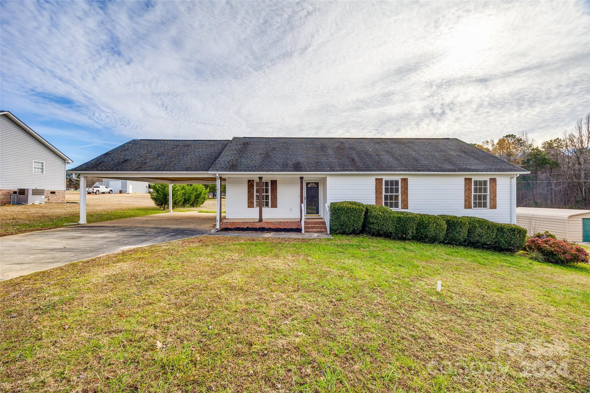 Cheerful single floor home with spacious acreage. The interior features a bright, modern kitchen with brand new stainless steel appliances and elegant white countertops; fully updated glamorous bathrooms with upgraded vanities and flattering lighting; seamless, durable luxury vinyl plank (LVP) flooring throughout; Large walk in closets in every bedroom; Ceiling fans in every room keep the house comfortable year-round. The outdoors features an expansive detached 2 story garage workshop, perfect for hobbies, projects, or extra storage. A covered carport protects your vehicles from the elements. Greet guests and sip coffee on your inviting covered front porch; entertain or relax on the sunny back deck. This charming property is situated on a peaceful, sunny setting on a generous 1 acre lot. The home offers the perfect blend of comfort, functionality and outdoor space. It is ready to impress. Schedule a showing today and make this cheerful home yours!