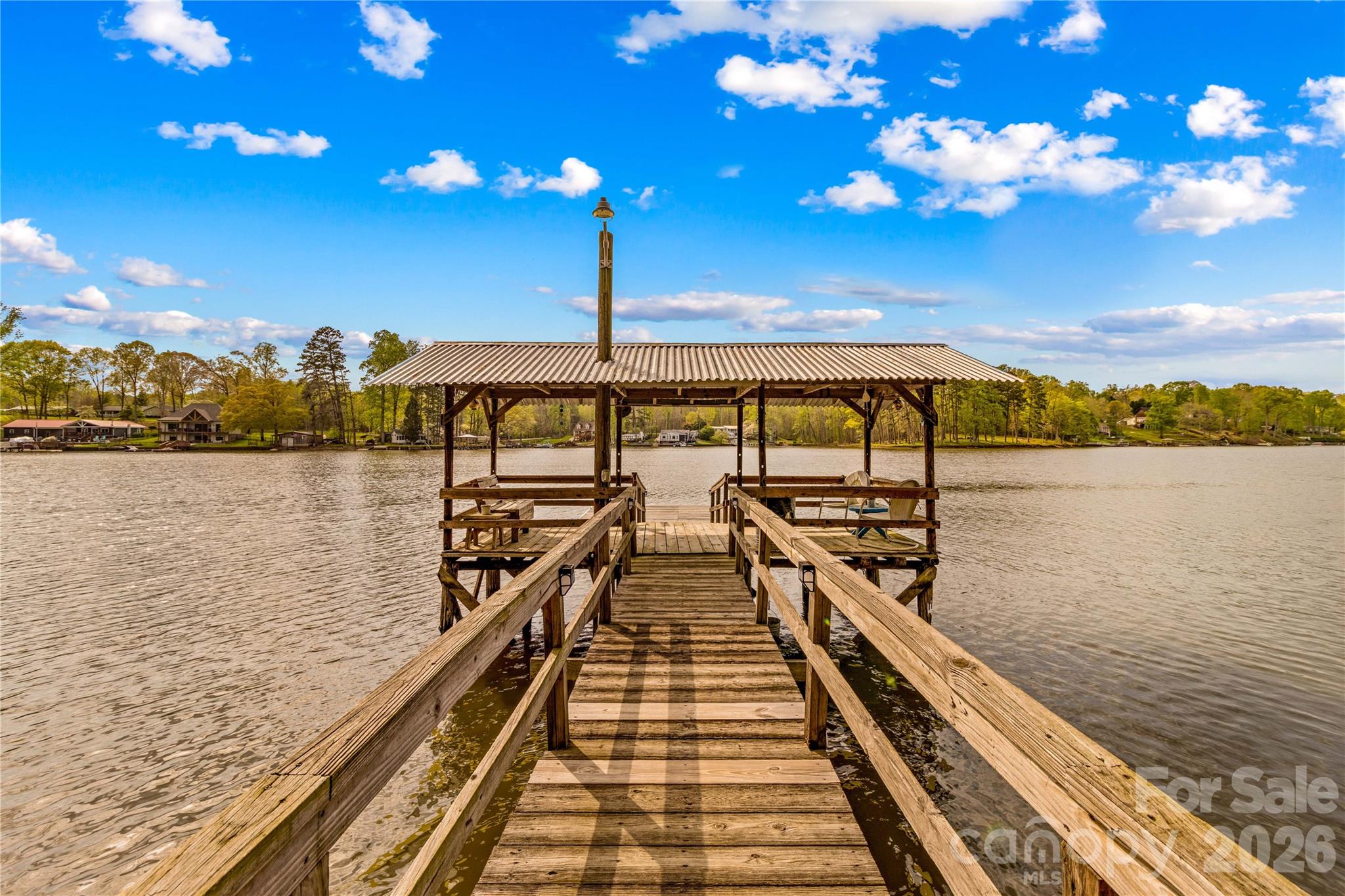 True Fisherman's cottage with unbelievable water frontage and year-round, long-range views for under 400k! If that wasn't enough, this property boasts additional rare features such as a stationary covered pier (grandfathered in; you can't get these anymore), a floating dock, and an attached boat house/marine garage complete with climate control, a rail system, and a motorized wench! The woodburning stove makes this property perfect for enjoyment in any season, an open kitchen showcases a unique hardwood breakfast bar ideal for entertaining, and the living area couldn't be any closer to spectacular views! The property also has 2 outbuildings, 1 of which is wired with electrical, new paint in the kitchen and on much of the trim, a new hot water heater, and new pier supports! Book your showing today! *Appliances and wood swing to remain with the property! (Sellers open to leaving lake themed decor).