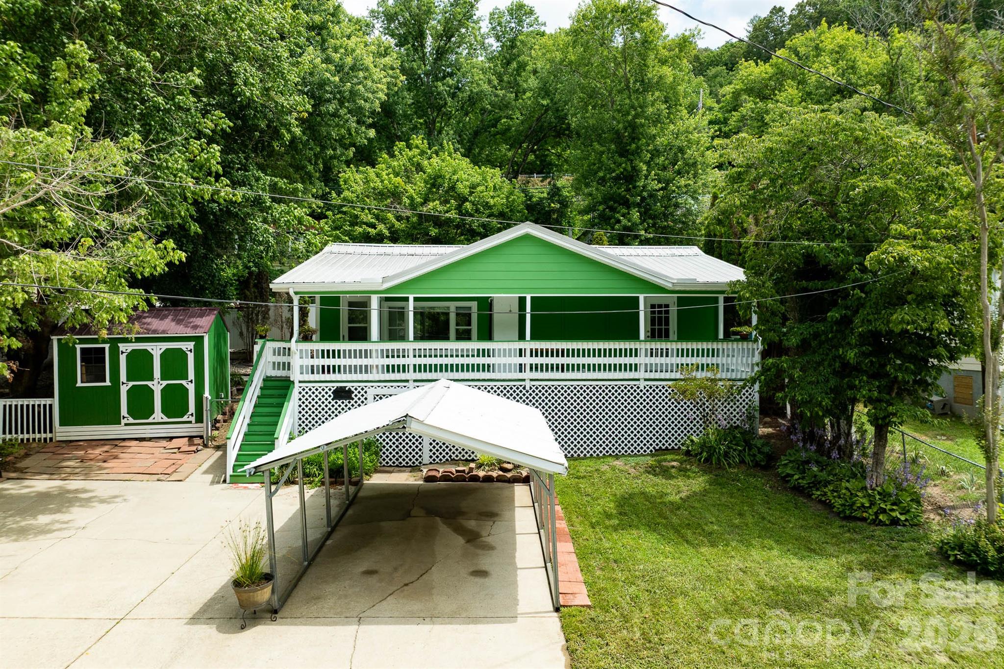 Wake up to the sights and sounds of the river at this beautifully renovated waterfront cottage just minutes from downtown Marshall. Setting directly across the street from the French Broad River, this property offers rare true riverfront living with peaceful water views and the soothing sound of flowing water as your everyday backdrop. Enjoy fishing, relaxing by the water’s edge, or simply taking in the natural setting from your own property. Inside, the home has been thoughtfully updated from top to bottom and features granite countertops, stylish finishes, and a bright, inviting interior. Large windows bring in natural light and frame the river setting, enhancing the connection to the outdoors. Conveniently located with easy access to Weaverville and Asheville, this turnkey property is ideal as a full-time residence, second home, vacation retreat, or investment opportunity. Riverfront homes this close to downtown Marshall are increasingly rare.