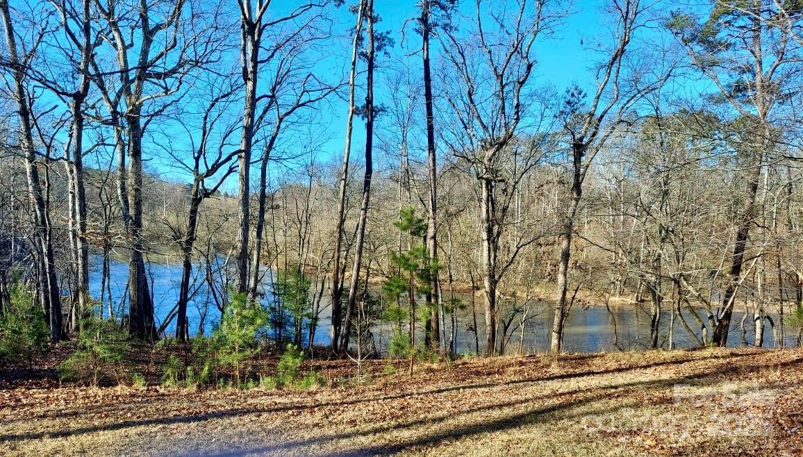 2.64 ACRES (and more land available) on Beautiful Lake Lee! Zoned R20 and dividable! If lake life is calling, look no more. Private and dreamy, and a fisherman's paradise! Directly across the street from Bridgewater and minutes to the city yet secluded and ideal for an estate life on the water. The home is situated on top of a lovely knoll for beautiful views! Three bedroom, two bath sprawling ranch with large kitchen and a 2 car garage and covered front porch. Tucked in the trees with a winding driveway that leads to the home. Please do not disturb the tenant. Lease ends in December 2025. This is such a great opportunity for private owner or developer. This property is in ETJ for Monroe. Call for a viewing today.