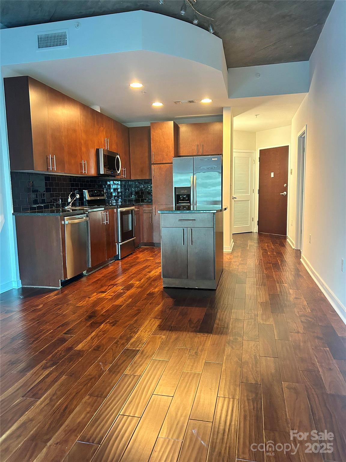 Be a part of the thriving Uptown scene at the Avenue Condominiums.   Step outside and walk to restaurants, bars, and sporting events or stay in and enjoy resort-style amenities-a heated pool, fitness center, clubhouse lounge, and an outdoor fireplace-all just a quick elevator ride away.  Building also features 24 hour concierge, key fob entry, Amazon lockers and business center for your convenience.  This open floor plan showcases a movable kitchen island, hand-scraped acacia engineered wood floors, granite countertops, and fresh paint throughout.  The bedroom includes a built-in computer niche with overhead cabinetry and a sliding door leading to a balcony overlooking the pool. This unit is move in ready! ***HOA also includes Google fiber internet and water(varies according to use).
Secured parking included one deeded spot.  Street parking and guest spots available in deck for a fee.