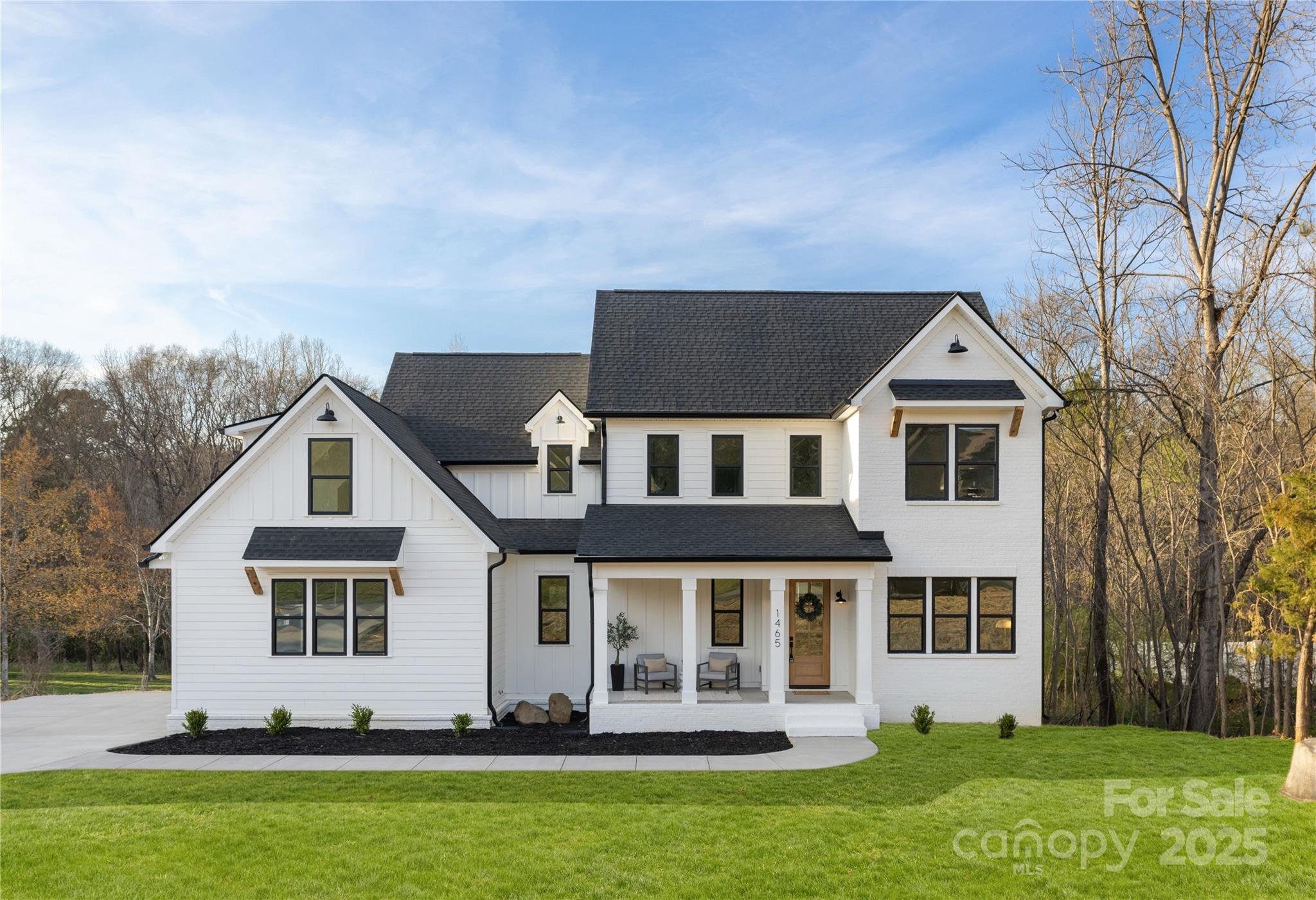 This beautifully crafted transitional farmhouse, completed in 2025, is a true testament to quality and design. Built well beyond standard codes, this home offers superior durability and efficiency. The kitchen is a standout, boasting premium finishes, generous counter space, and ample storage - all harmoniously designed to complement the chandeliers and other finishes throughout the home Large, European-imported energy-efficient windows and a rear accordion door enhance insulation while flooding the home with natural light, creating a bright and welcoming atmosphere. Elegant wood flooring runs throughout, adding warmth and character to every space. Outside, a spacious extra-wide, long driveway offers ample parking, while covered porches (front and rear) provide the perfect setting to relax and enjoy the surroundings. This home is a rare blend of craftsmanship, efficiency, and style—don’t miss the opportunity to make it yours!