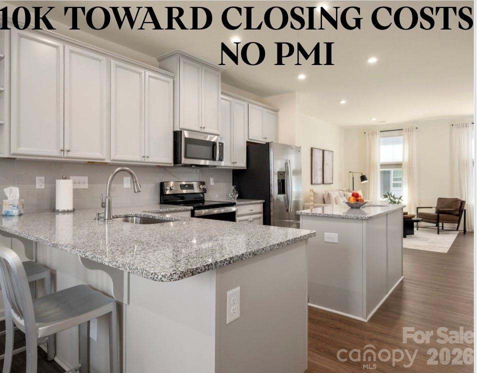 Experience urban LoSo living at its best—just steps from the light rail for unbeatable convenience. This move-in ready home features luxury vinyl plank flooring, stylish light gray 42" cabinetry, gray subway tile backsplash, granite countertops and custom shades! Enjoy a private terrace perfect for relaxing or entertaining, along with a rare 2-car tandem garage offering plenty of storage. Inside, the bright and open layout is complemented by neutral paint throughout. The spacious kitchen shines with a large island, stainless steel appliances and abundant storage, including a pantry and additional utility closets. The split-bedroom floor plan provides ideal flexibility for roommates, guests or a home office. All appliances convey—including the refrigerator and in-unit stackable washer and dryer—making this an easy, turnkey opportunity. Enjoy a energy-efficient home with two HVAC zones and two smart thermostats you can control from your phone, low HOA dues, an unbeatable light rail location and quick access to major roadways. Priced below tax value! Property qualifies for 100% financing, no PMI and up to 10k in closing costs!