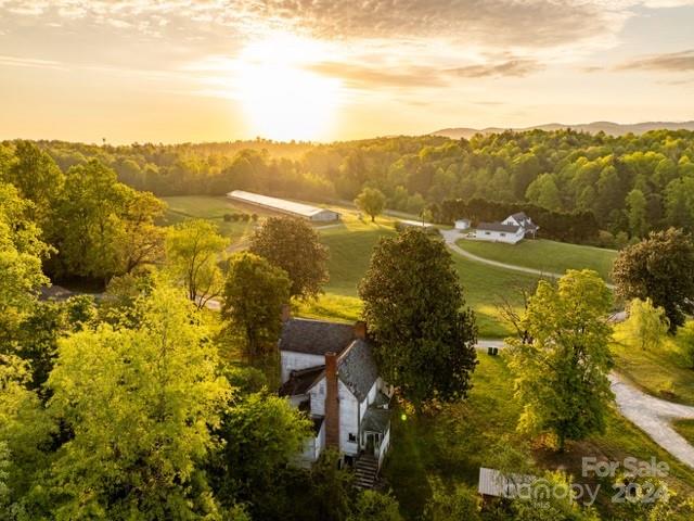 Warrior Creek runs through this 150 Acre Farm that reflects Historical times AND the “Kissing Rock” sits beside the rolling creek…    Horse Farm or other livestock will welcome these 150 acres +- of open land along with growing timber. This Beautiful, Serene Farm IS the American Dream. Mountain views, 2 move-in ready residences, each with their own well and septic. Numerous building sites for the entire family to enjoy building their own… Large building with plenty of room for hay and horse stalls. Several outbuildings. Old 1800’s Farm House takes you back in time. Conveniently located near the Moravian Falls area, "The American Dream Lives Here" .