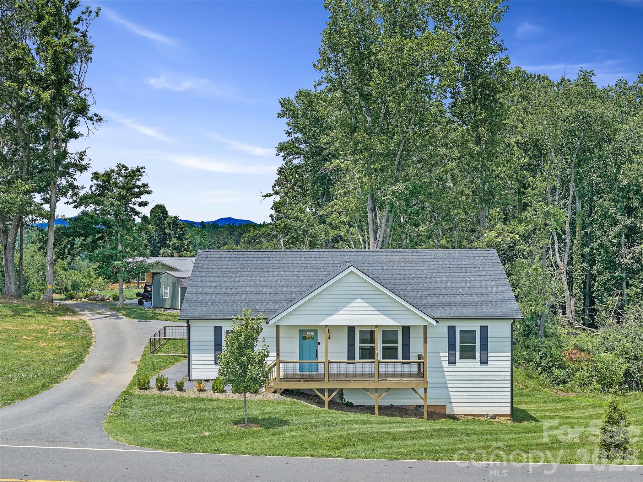 One level living with VIEWS and convenience in Asheville! This like-new home boasts an open floor plan with gorgeous quartz countertops in the kitchen that flows seamlessly into a generous living room. 2 guest bedrooms surround a full bathroom on one side of the home, and a luxurious primary bedroom with en-suite bathroom and walk-in closet sit perfectly on the opposite side. A second entrance through the mudroom/laundry provides lots of storage and easy access, but the 2 covered porches might just be the best part! Enjoy long-range pastoral and mountain views off the front deck, or choose tree-house vibes and privacy off the back deck. With plenty of parking and a fenced-in backyard for your pets, this like-new home lives EASY!