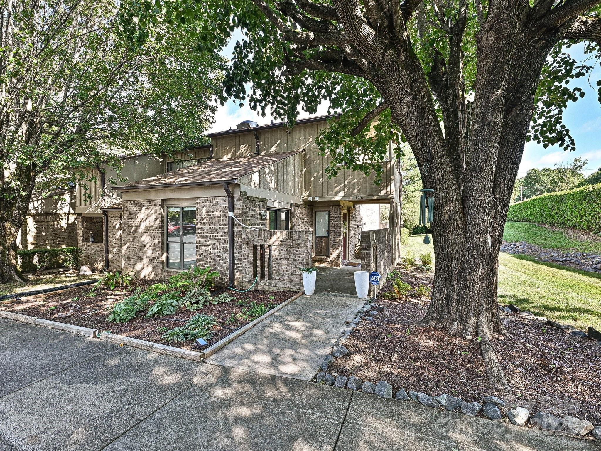 Welcome to 7916 Charter Oak Ln! This 1132 sq ft. freshly painted, 2BR/2BA end-unit townhome offers the ideal mix of style, comfort, and smart upgrades in a prime location near SouthPark and charming downtown Pineville. Newly renovated bathrooms (Feb 2025), LVP flooring on the main level, kitchen w/ granite counters and overhang for barstools, newer SS appliances, and white shaker cabinets (2022). Cozy up to the fireplace in the living room which features a custom wood-paneled ceiling, new fan, and remote-controlled blinds for the upper windows. Other thoughtful upgrades include new window treatments and ELFA closet systems in both bedrooms. Relax outdoors with your own enclosed back patio or balcony off the primary bedroom—perfect for morning coffee or winding down at the end of the day. Or take a short walk to the neighborhood Pool to cool off during the summer. Roof replaced in 2022, plus new gutters w/ leaf guards. Move-in ready and low maintenance--this one checks all the boxes!