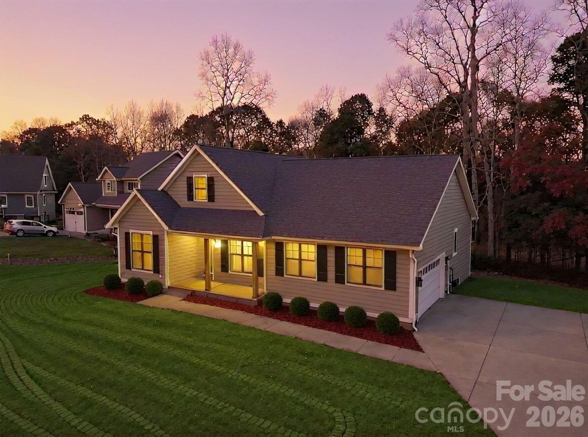 No detail has been overlooked on this new construction home on a .77 acre lot. The residence features a large living room highlighted by a custom vaulted wood ceiling, a fireplace, and large windows that provide views of the expansive back porch, which also boasts a vaulted wood ceiling.

The gorgeous kitchen is equipped with custom cabinets featuring soft-close doors and drawers, a lazy Susan, granite countertops, and stainless steel appliances, all complemented by a beautiful wooden hood vent feature. 

The primary suite offers a vaulted ceiling, a walk-in custom closet with built-in shelves, and a full bath featuring a tile shower, water closet, dual vanity, and granite countertops. Hardwood and tile floors run throughout the home, and it includes a side-entry two-car garage.