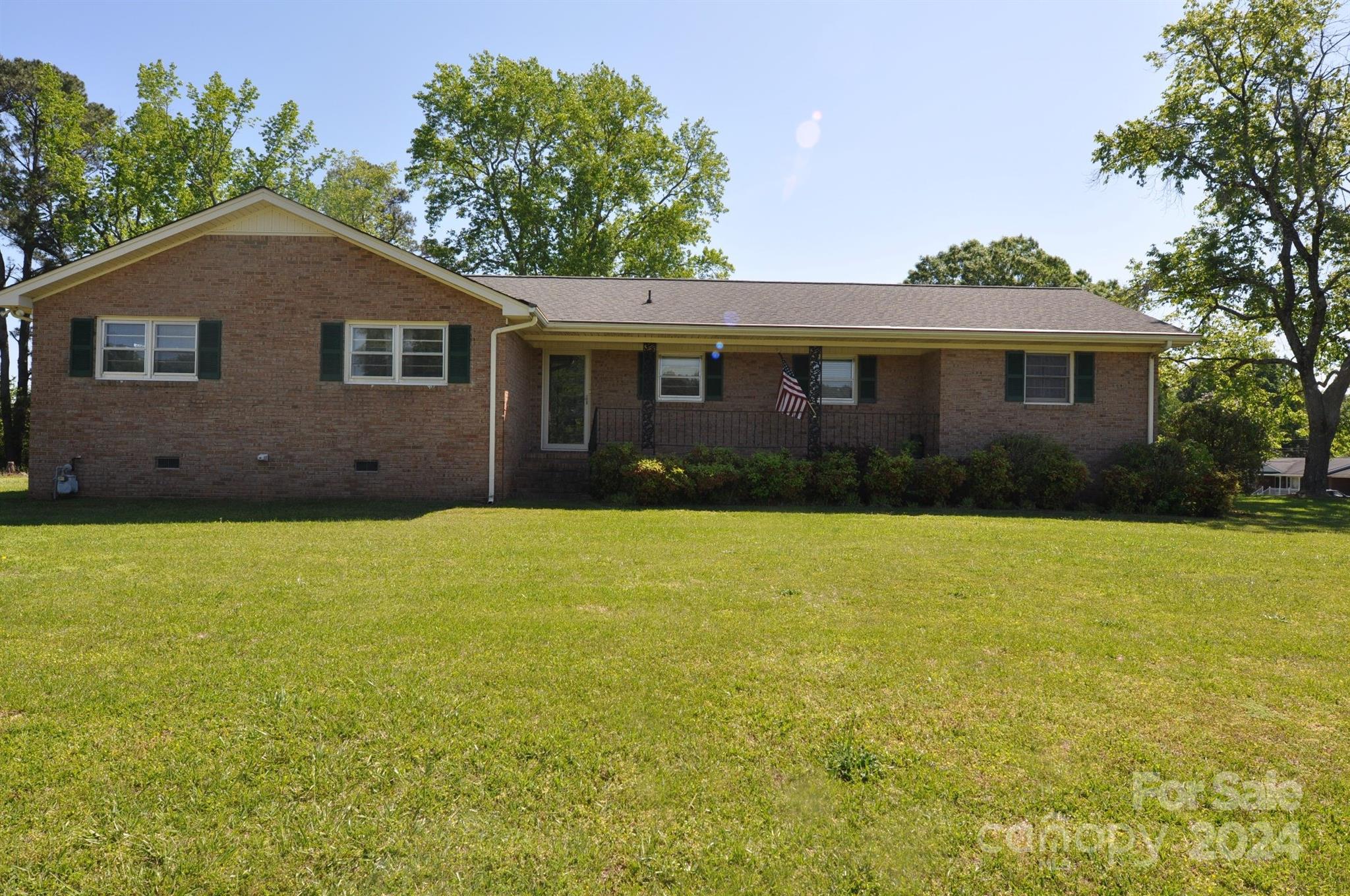 This three bedroom 1.5 bath  all brick home is situated on a generous corner lot of approximately 0.825 acres, providing ample space. There are three bedrooms, all with hardwood floors, providing a classic and elegant look.
The main bathroom features a tub/shower combo, while the master bedroom has a convenient half bath with ceramic tile flooring. The kitchen boasts a breakfast bar, all wood cabinets, and appliances including a wall oven, dishwasher (recently replaced), and refrigerator. The kitchen and breakfast area have been updated with vinyl plank flooring, offering durability and easy maintenance. A one-car attached carport provides sheltered parking, and the property has its own well and septic system, which can offer cost savings and independence from municipal services. Convenient access to Rock Hill.  Come make this house your new home. Seller offering $7500 in buyers closing costs