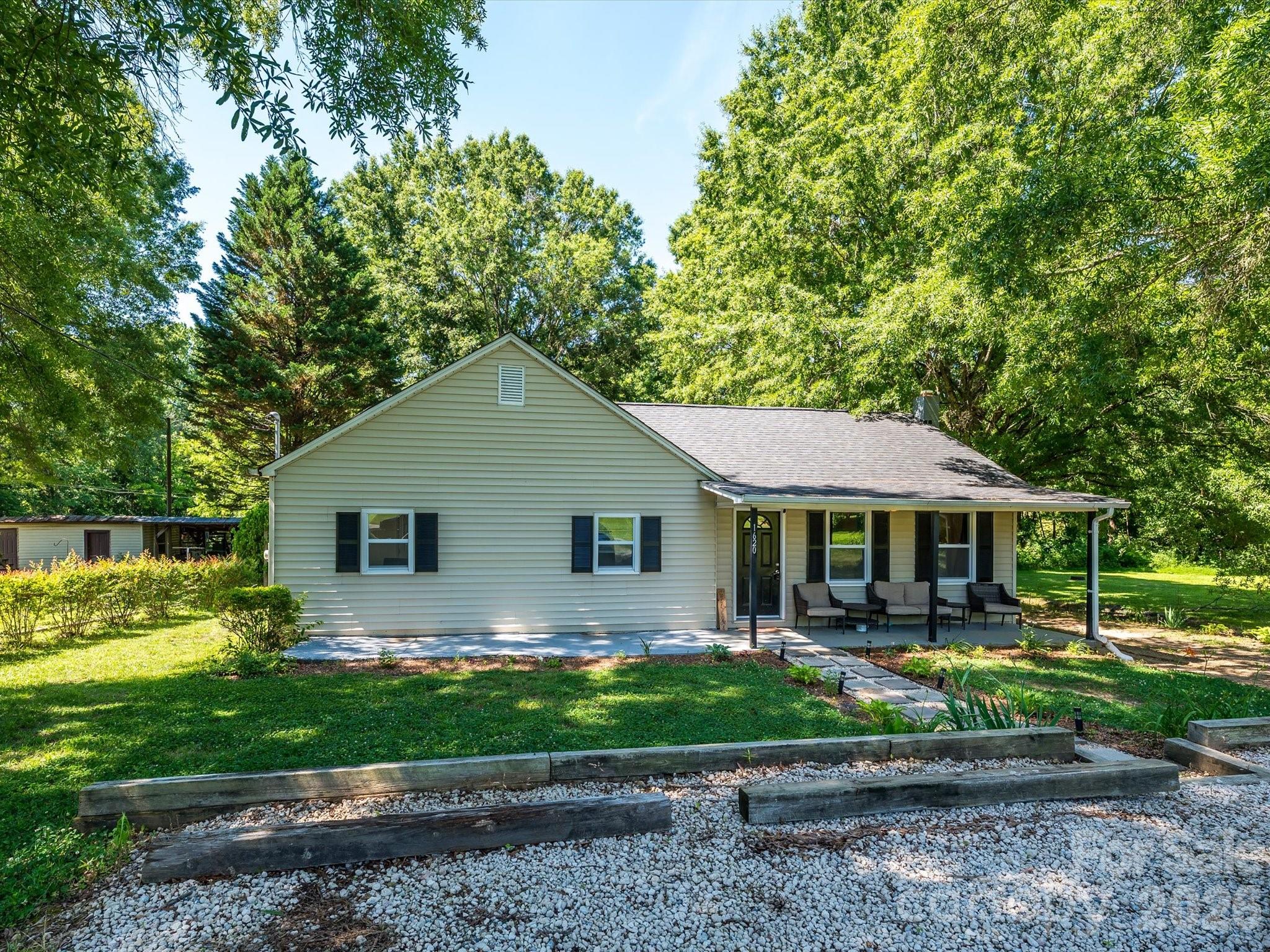 Conveniently locate just down the road from the picturesque downtown of Mount Pleasant with restaurants, boutiques, coffee shops, and more.
A nice paved walkway leads to a covered front porch, with an additional uncovered porch area. This updated 1920 home has vinyl siding and replacement windows.  The roof was also replaced in 2019! 

Entering through the front door, you step into a foyer with beautiful wainscoting and new LVP flooring that continues throughout the home. The great room features canned lighting and opens to the dining area and kitchen.

The newly (2019), renovated kitchen offers a center island with updated granite countertop, new cabinets, an exhaust hood, a smooth-top electric range, and seating space for at least three people. Additional features include white cabinetry, a 50/50 split sink with a gooseneck faucet, and a door leading to the backyard.

The backyard is private and includes a paver patio and an outbuilding with electricity.

Down the hall, there is attic access, a hall bathroom with LVT flooring, an updated vanity with a marble top, updated lighting, an updated mirror, and a tub/shower combination.

Across the hall is a bedroom with LVP flooring, with a second bedroom next door. Across from that bedroom is the owner’s suite, which features dual closets, a ceiling fan, LVP flooring, and an en suite bath. The owner’s bath includes LVT flooring, a shower, an IKEA-style furniture vanity, updated lighting, and an updated mirror.

The laundry room has hallway access, LVT flooring, and a new water heater installed in 2025. The laundry room can also be accessed through the owner’s suite bathroom.

Refrigerator, washer, and dryer are negotiable.