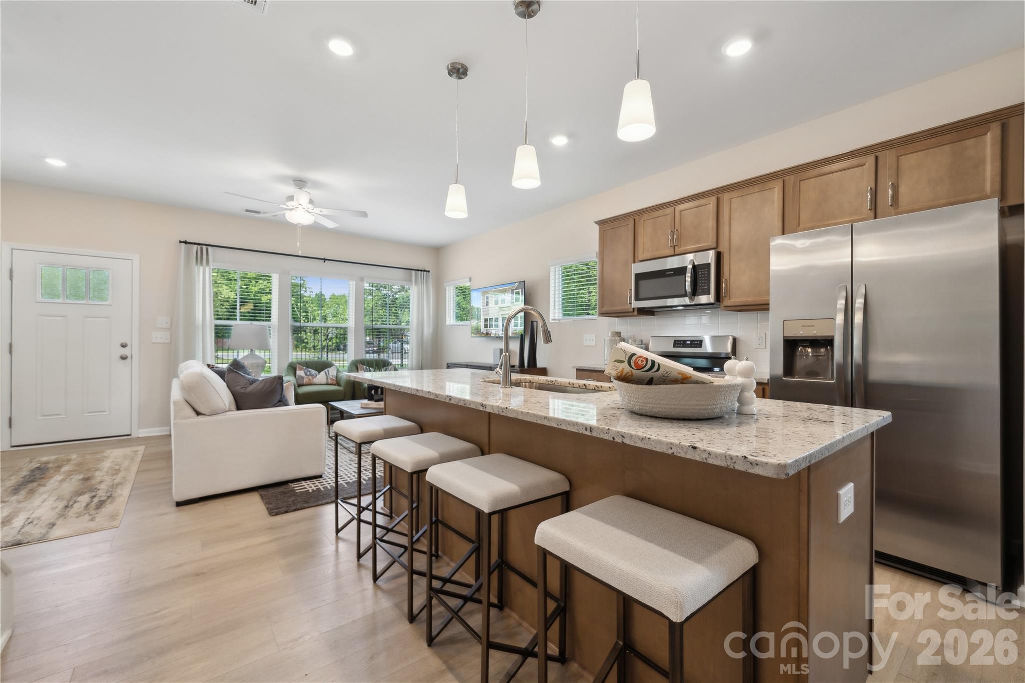 Step into this beautifully designed two-story townhome featuring three bedrooms and two-and-a-half baths, thoughtfully crafted for modern living. Just inside the entry, you’re welcomed by a spacious open-concept great room that seamlessly connects to the kitchen and inviting eat-in dining area—perfect for both relaxing evenings and entertaining guests.

Upstairs, the primary suite offers a peaceful retreat with a stylish boxed ceiling, a generous walk-in closet, and an en-suite bath complete with dual vanities. Two additional bedrooms and a full bathroom provide comfortable and flexible living space. A conveniently located laundry closet just outside the secondary bedrooms enhances everyday ease.

Additional highlights include a one-car garage with interior access, where you’ll find a powder room along with a functional drop zone featuring built-in bench seating and cubbies—ideal for staying organized while adding a touch of charm to the home.