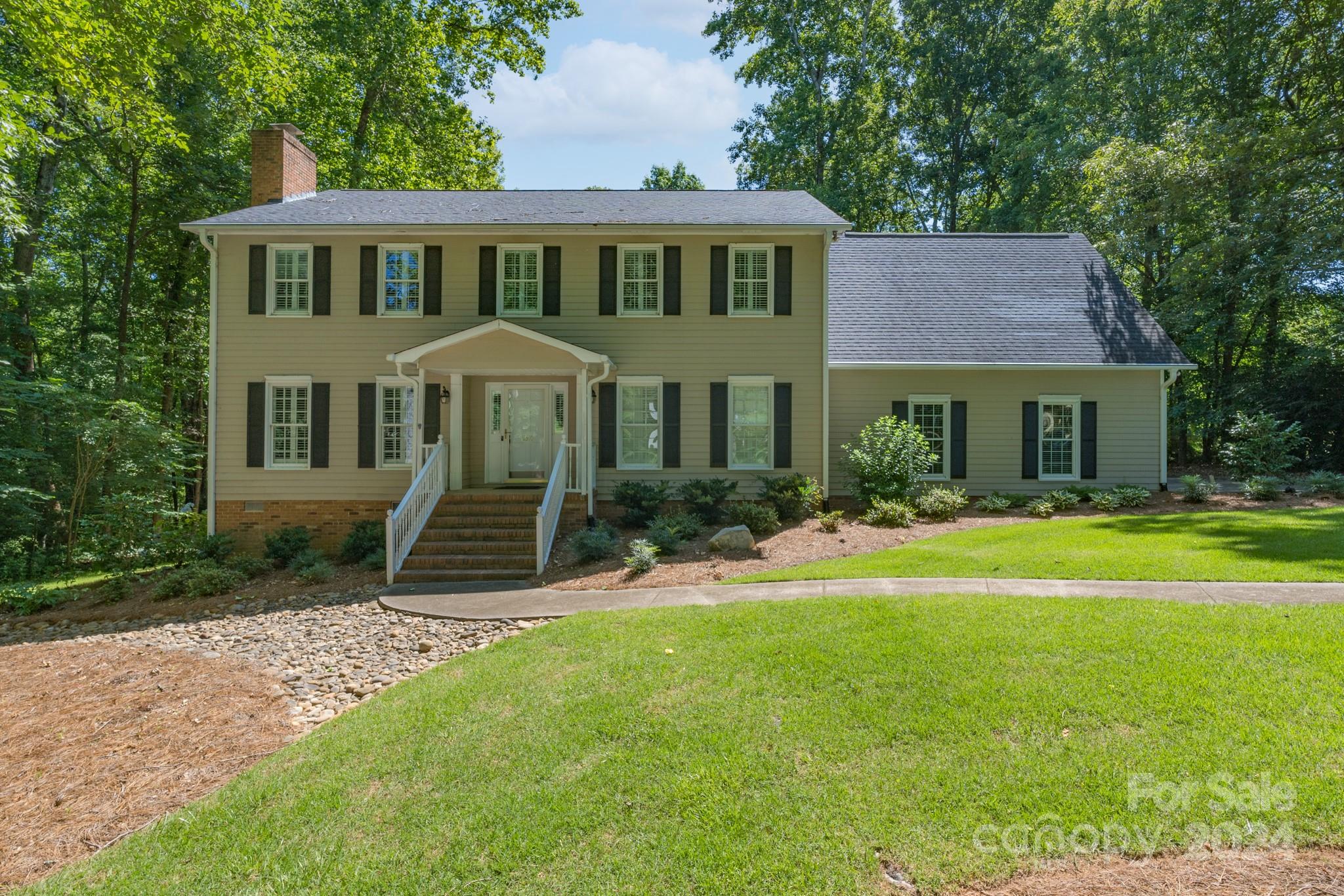 From the moment you drive up, you will be impressed with the beautiful yard and landscaping of this home.  It has been loved and well-maintained by the original owners and is ready to welcome you!  With four bedrooms and a bonus, this home with plantation shutters throughout will check off many of your boxes. The main floor features a family room with brick fireplace and gas logs, dining room, and kitchen with fabulous storage, granite countertops and a double oven. In addition, a bedroom on the main floor can serve as a second primary with an updated full bath. Upstairs is home to a primary bedroom with full bath, two additional bedrooms, a full bath, and a bonus room located off the bedrooms that has many possibilities. Looking for a place to relax and unwind? You will fall in love with the enclosed porch on the back of this home with year-round use that overlooks a spacious deck and great yard. Located on over a half-acre lot and with a double garage, this could be the one for you!