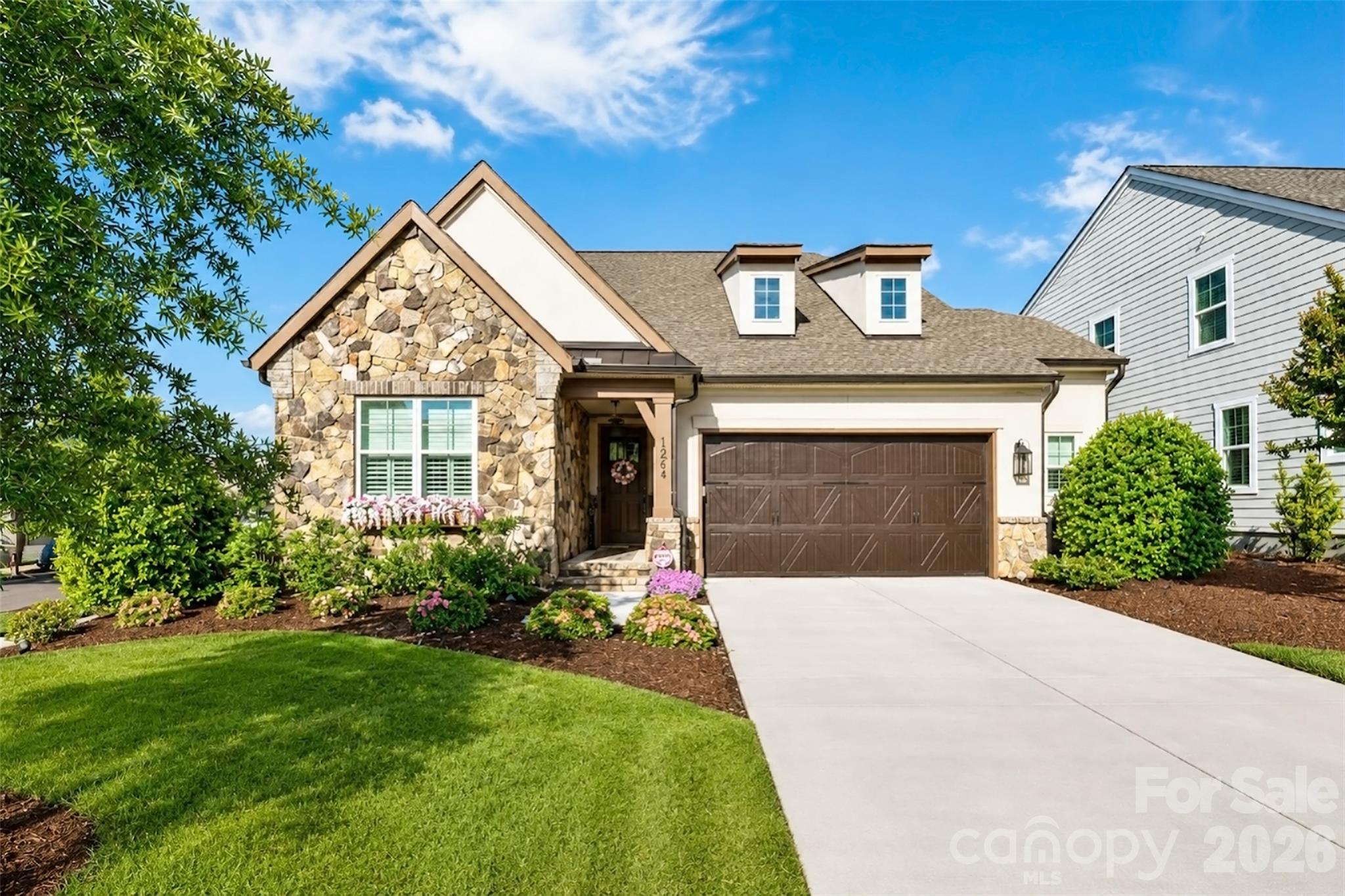 Step into refined living with this exceptional Classica Home in the desirable Huntson Reserve community. Designed with elevated finishes and functional elegance throughout, this home offers a seamless blend of sophistication and comfort.
The light-filled open layout is anchored by a designer kitchen equipped with top of the line appliances, quartz surfaces, premium cabinetry, and a striking tile backsplash. The adjoining living area features a gorgeous gas fireplace and opens effortlessly to a covered porch and extended pavered patio,ideal for indoor-outdoor entertaining. 
The main floor includes a luxurious owner’s retreat with a custom walk-in closet, along with a spacious secondary ensuite bedroom perfect for guests. A dedicated office, a practical drop zone, and a thoughtfully designed laundry room with direct access to the primary closet enhance daily convenience.
Upstairs, you’ll find a large loft with stunning custom deluxe wet bar, a versatile flex room currently serving as a home office/fitness room, a state of the art theatre room, and two additional ensuite bedrooms—an upgraded feature unique to this floor plan. There’s also a sizable walk-in attic offering excellent storage space.
Outside, enjoy a luscious backyard with professional landscaping, established irrigation, and plenty of room to relax or entertain. The covered patio features motorized privacy screens and tinted patio door and the garage is oversized and offers 2 and 1/2 size.
This home must be experienced! 
Residents of Huntson Reserve enjoy access to scenic walking trails, community green spaces, and an unbeatable location near Birkdale Village, Lake Norman, shopping, dining, and Rosemont Nature Park via Torrence Creek Parkway.