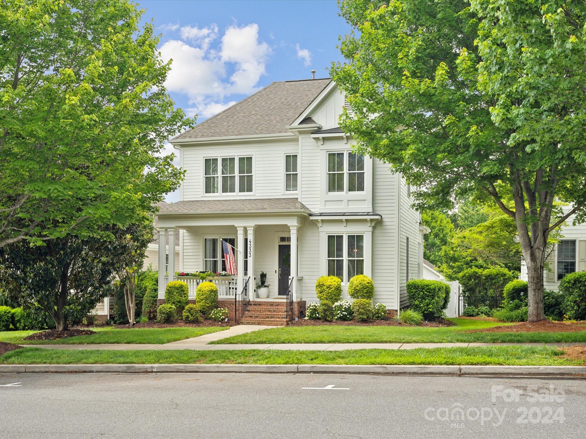 Introducing a beautiful 4-bedroom home in the sought-after Baxter Village neighborhood in Fort Mill! This home features hardwood floors throughout, a formal dining room, white cabinetry with gold hardware and granite countertops, a gas fireplace, and a flat, fully fenced backyard with a built-in stone fire pit and seating wall. The main level primary suite is an owner's oasis, boasting a large walk-in closet, a dual sink vanity, and a separate garden tub and walk-in shower. This uniquely modified Cotswold floorplan has been transformed on the second level: the large 4th bedroom/bonus space has been split into two rooms offering the ability to use these spaces as bedrooms, bonus or workout rooms, a study, or any other combination that best fits your needs! Conveniently located just a block away from the community pool and playground! Baxter Village features two pools, tennis courts, miles of walking/hiking trails, four playgrounds, and Market Street lined with shops and restaurants!