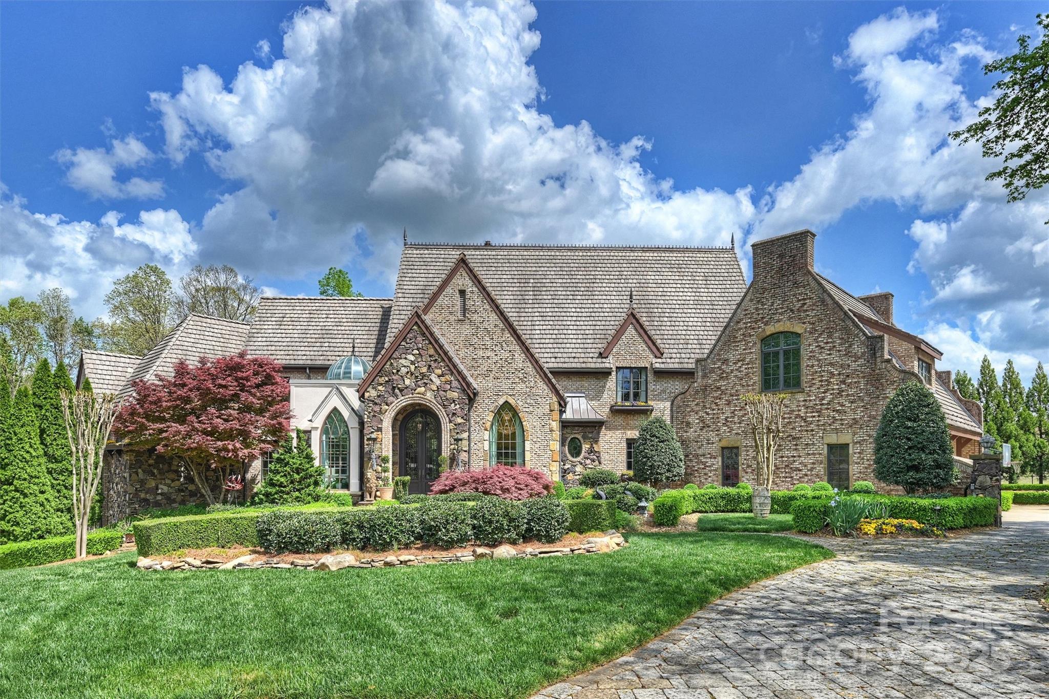 Extraordinary National Award-Winning custom luxury estate showcasing exquisite design & architectural mastery, nestled on nearly an acre in one of Weddington’s most coveted neighborhoods. One-of-a-kind Homearama
Masterpiece features unrivaled luxury enhancements, including gourmet kitchen, antiqued slate roof, Habersham cabinetry, & intrinsic finishes. Stunning solarium boasts an authentic English Conservatory with an 8-foot glass dome, while the grand brick-barreled foyer sets the tone for refined elegance. The thoughtfully designed floor plan offers a main-level primary suite, soaring beamed ceilings, & exquisite designer details throughout. Entertain effortlessly with a spacious recreation & media room, 4 fireplaces, & 4 wet bars, plus a separate guest quarter on the lower level. Exceptional outdoor living awaits—koi pond, waterfalls, pool, hot tub, porches, outdoor kitchen & dining—all complemented by a guest/pool house featuring an open living flex area, a sauna, & a pool bath.