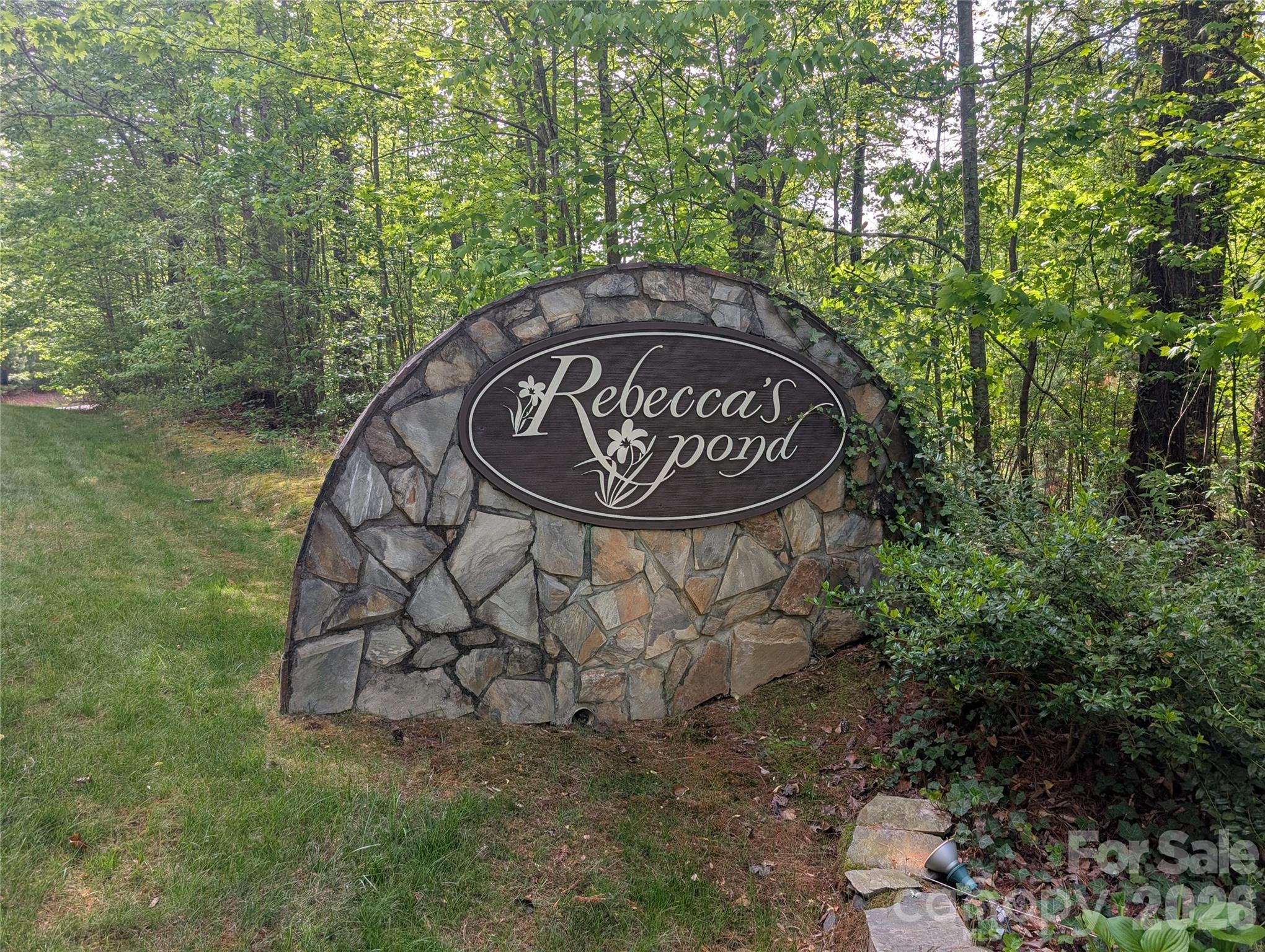 Embrace the perfect balance of seclusion and convenience with this stunning 2-acre wooded sanctuary nestled at the end of a quiet cul-de-sac in the prestigious Rebecca’s Pond community. This gently sloping lot offers an ideal canvas for your dream home, providing a private, natural escape that remains just 9 minutes from the vibrant shops and dining of Main Street Hendersonville. Outdoor enthusiasts will fall in love with the proximity to DuPont State Recreational Forest, while the community’s own amenities offer a resort-style lifestyle right at your doorstep. Spend your afternoons kayaking on the serene pond, or gather with neighbors at the impressive waterside pavilion, complete with a fire pit for cool Carolina evenings. It’s more than just a homesite; it’s the peaceful mountain retreat you’ve been waiting for. The 10 year special assessment from the HOA has been paid in full!