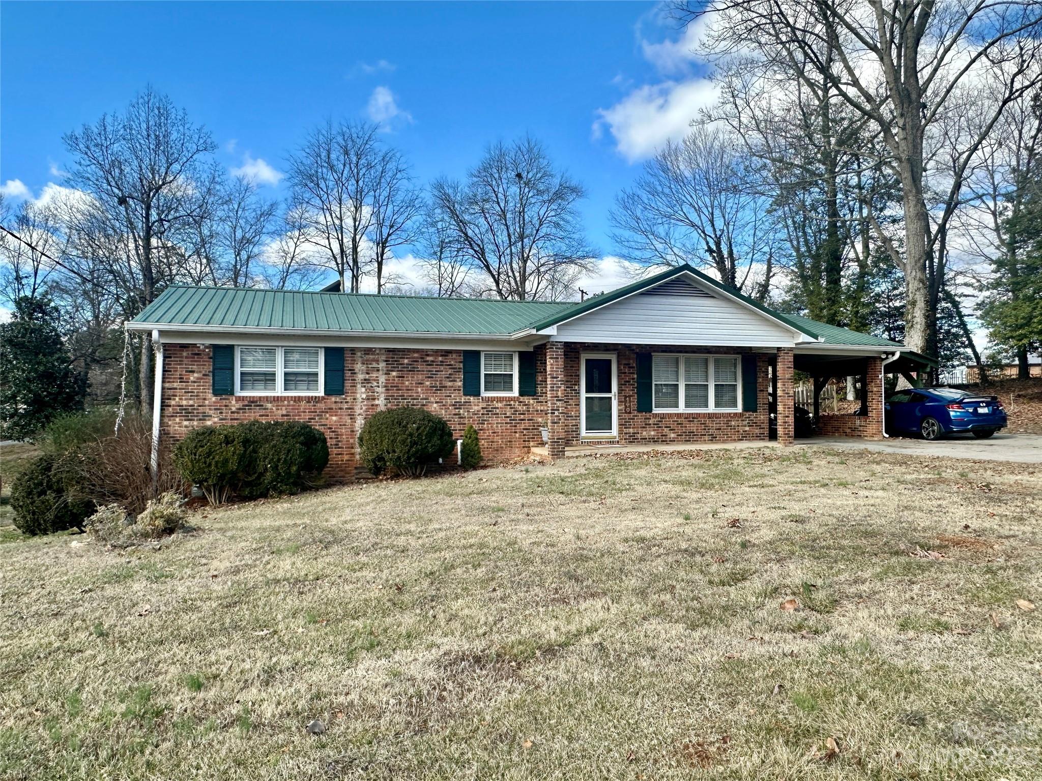 This 3 bedroom, 1.5 bathroom brick ranch comes with 2 lots totaling .69 acres. There is a front driveway as well as a back driveway off Elm Street. The open living room, kitchen, and dining area create a spacious and welcoming atmosphere. The sliding double door at the dining area gives access to a great covered back porch and patio offering lots of room for outdoor entertaining. Having a garage door in the basement and a main-level carport provide convenient access and parking options. The property's location in Hudson, with walkability to events, restaurants, and other amenities, adds to its appeal. Additionally, being conveniently located just minutes from Highway 321 enhances the property's accessibility and connectivity to surrounding areas.