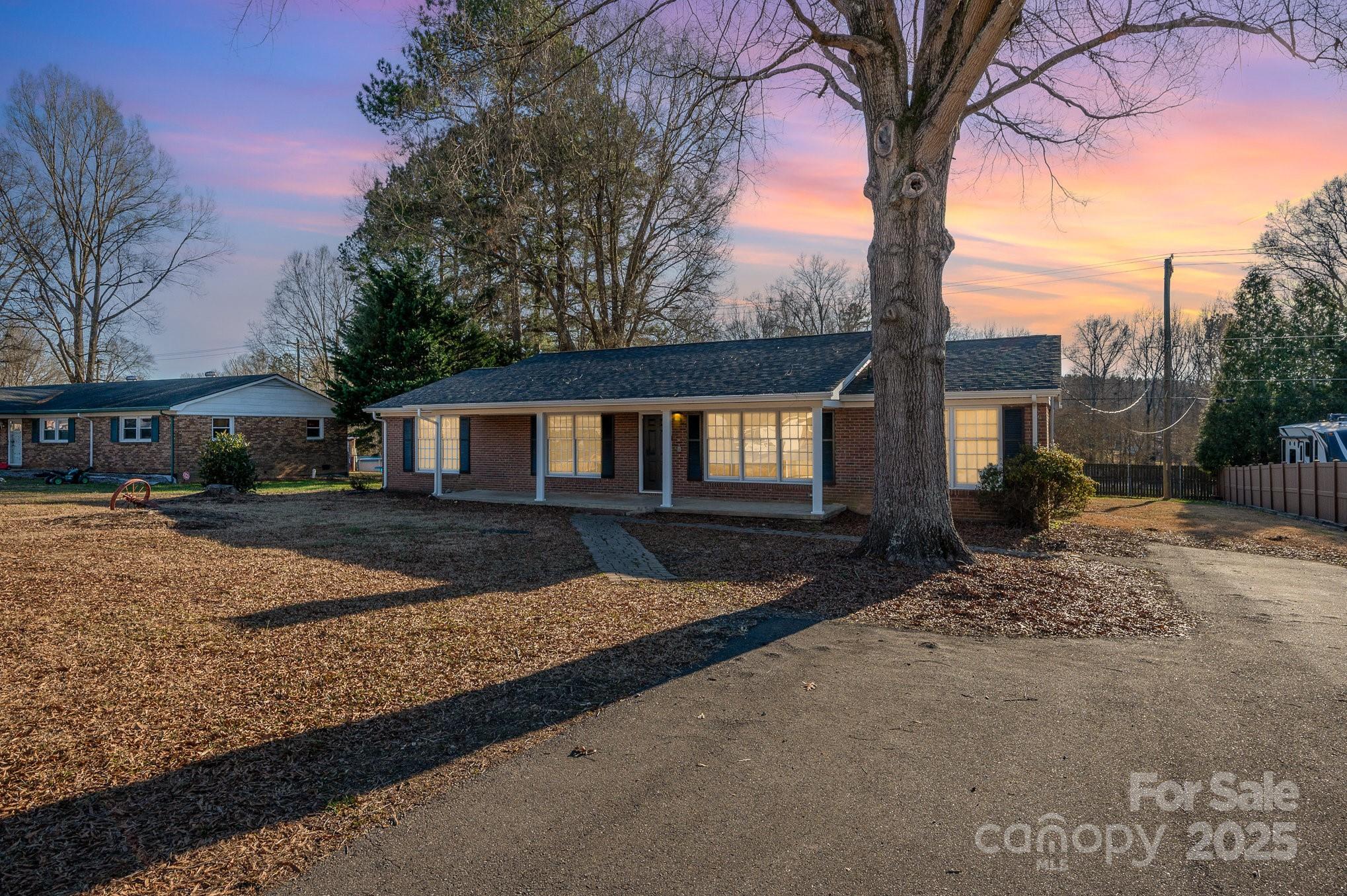Don't miss this beautifully updated home on .37 acres in the desirable Southgate neighborhood, just outside of Gastonia city limits. This 1 story brick home has a beautiful rocking chair front porch and back deck for entertaining or relaxing. Enjoy cooking in your updated kitchen that features new cabinets, granite countertops, and stainless steel appliances. Don't miss the elegant tiled bathrooms with granite vanities! You'll love the original hardwood floors in bedrooms, lvp in main living areas, new carpeting and fresh paint throughout. Large level backyard with deck + newer shed!  The crawl space has previously been professionally upgraded with a DryPro-installed dehumidifier and sump pump system , designed to regulate the home's temperature and boost the efficiency of the new HVAC system. Don't miss the addional storage in the covered parking area! This cozy home, situated near top-rated schools, won’t last long!