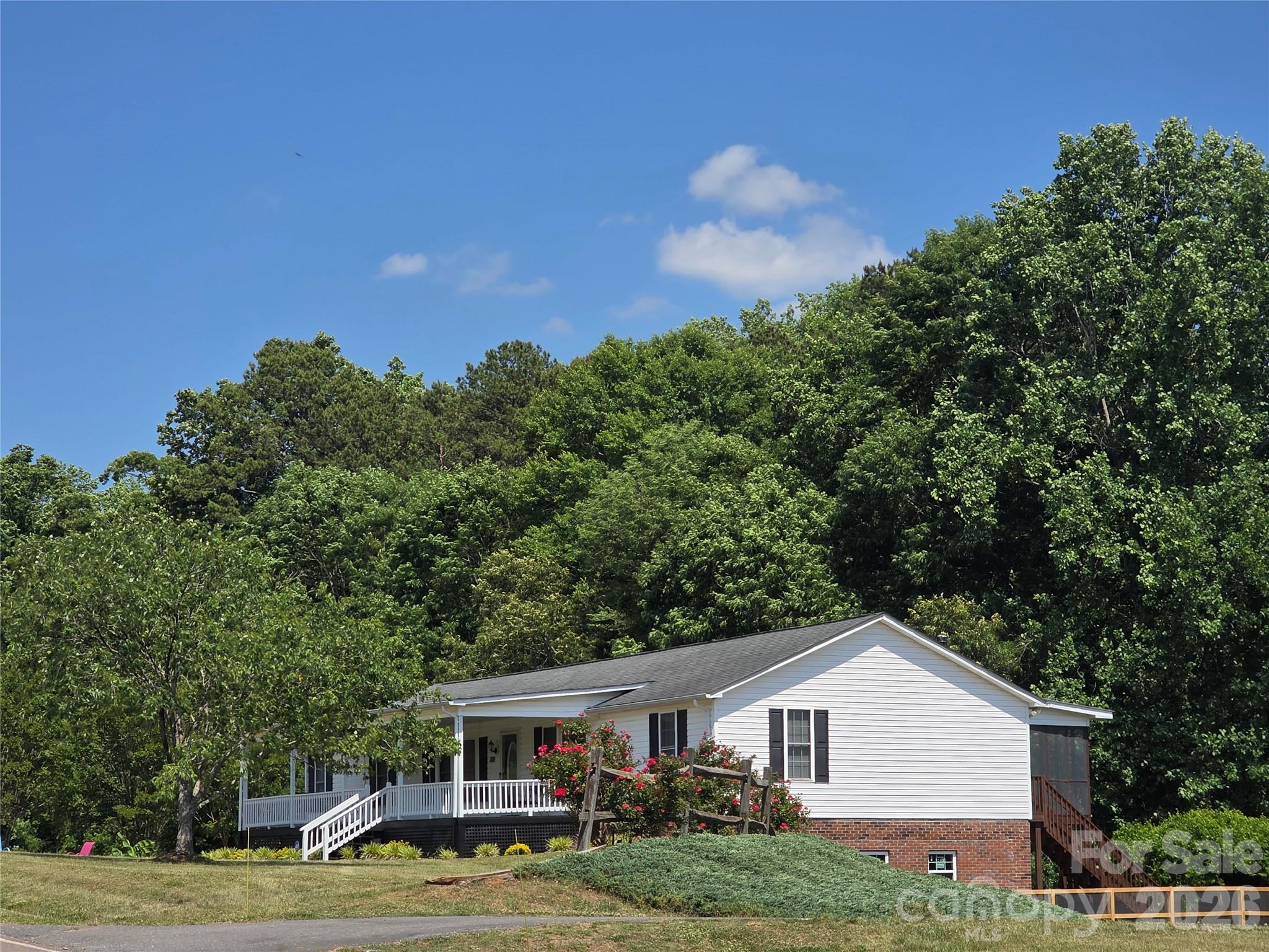 Charming 9.5-Acre Mini-Farm & Ranch style Home – A Rare Find! Escape to your own private homestead on 9.5 acres of beautiful, versatile farmland. Perfect for horses, livestock, or homesteading, this well-maintained property blends rustic character with modern comfort with solar panels. Main Level Living: This spacious 1,900 sq ft ranch features an open living room with massive windows offering stunning views, plus a cozy den anchored by a stone fireplace and custom built-ins. It has a desirable split-bedroom floor plan that offers privacy. The large primary suite boasts a walk-in closet, while the two additional generously sized bedrooms feature brand-new carpet. You'll find 2 full baths on the main level. A bright, open kitchen with abundant countertop space and a premium gas range—perfect for the home chef. The Bonus Spaces -are a Massive Finished Basement: The 1,950 sq ft lower level is a true gamechanger. Beautiful brand-new shiplap ceiling, a full bath, laundry area, and a second kitchen. It’s perfect for a second living quarters, guest suite, or the ultimate entertaining and gardening hub. Enjoy year-round comfort with central air/heat, upgraded with high-efficiency mini-splits (added in 2025). The Acreage & Outbuildings: The Barn is a character-filled 36x48 barn equipped with 4 stalls and stairs leading to a spacious loft. There is 24x35 metal building (built in 2025) featuring 12-ft overhangs—ideal for garage, equipment, boats, or a workshop and 2 additional multi purpose outbuildings can be found on the property. There's a lovely greenhouse, established fruit trees, and grapevines that await your green thumb. The property also features a fully fenced yard area, perfect for pets or play. This hard-to-find, move-in-ready property is a dream come true for hobby farmers and outdoor enthusiasts alike.