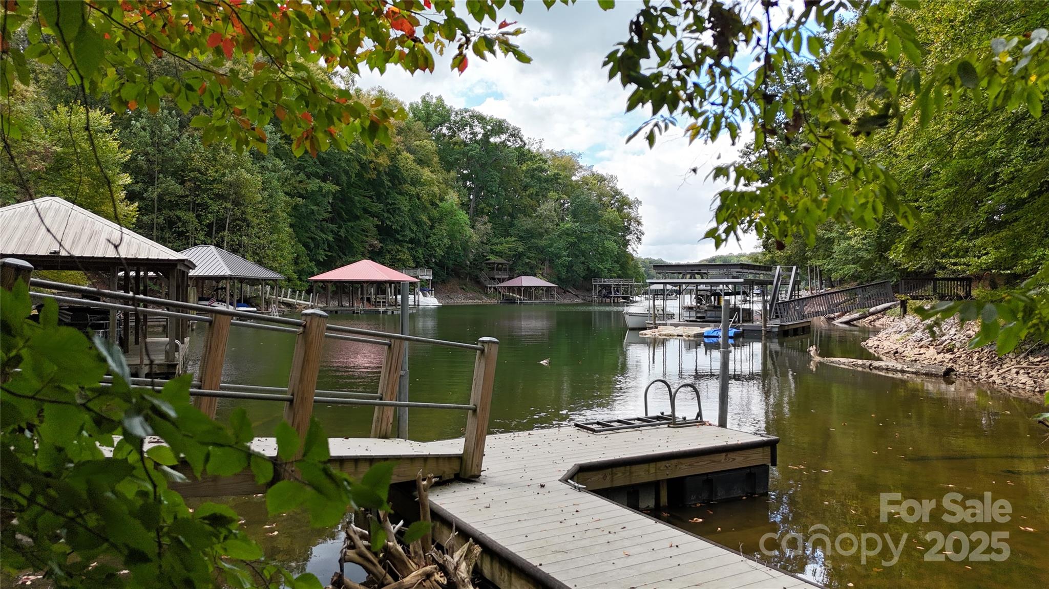 Your dream lot awaits in the gorgeous gated community of Harbor Watch! Waterfront with a PRIVATE DOCK and surrounded by large mature trees and rolling hills, this lot offers the peaceful landing place for a weekend retreat from Charlotte or for your forever home. With the minimal building requirement of 1,800 sf, bring your builder and design your waterfront escape the way you want it to be. Harbor Watch Neighborhood amenities include a community day dock, boat launch, picnic and fire pit waterside recreation area, two stocked ponds for catch & release fishing and two private islands!