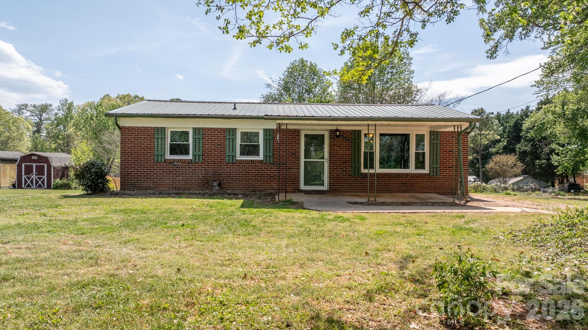 Investors, DYI Gurus, Flippers, & Visionaries - This is Your Opportunity! This 3-bedroom, 1-bath brick ranch offers excellent potential as a home for you, a rental property, flip, or value-add investment. The home features an open-concept living area, fresh paint throughout, and several major updates. Per the seller, the metal roof, HVAC system, and windows were replaced in 2022, and a new electric water heater was installed in 2023. The kitchen has a newer cooktop, wall oven, dishwasher, and refrigerator. They are also leaving the washer and dryer. Oh, wait! I forgot to mention they found original hardwood floors under the carpet. Outside, you'll find a large front porch, spacious yard with plenty of room to enhance value and appeal. With big-ticket items updated, this property presents a great opportunity for you to create the home you've always wanted or to add to your portfolio or start your next project.