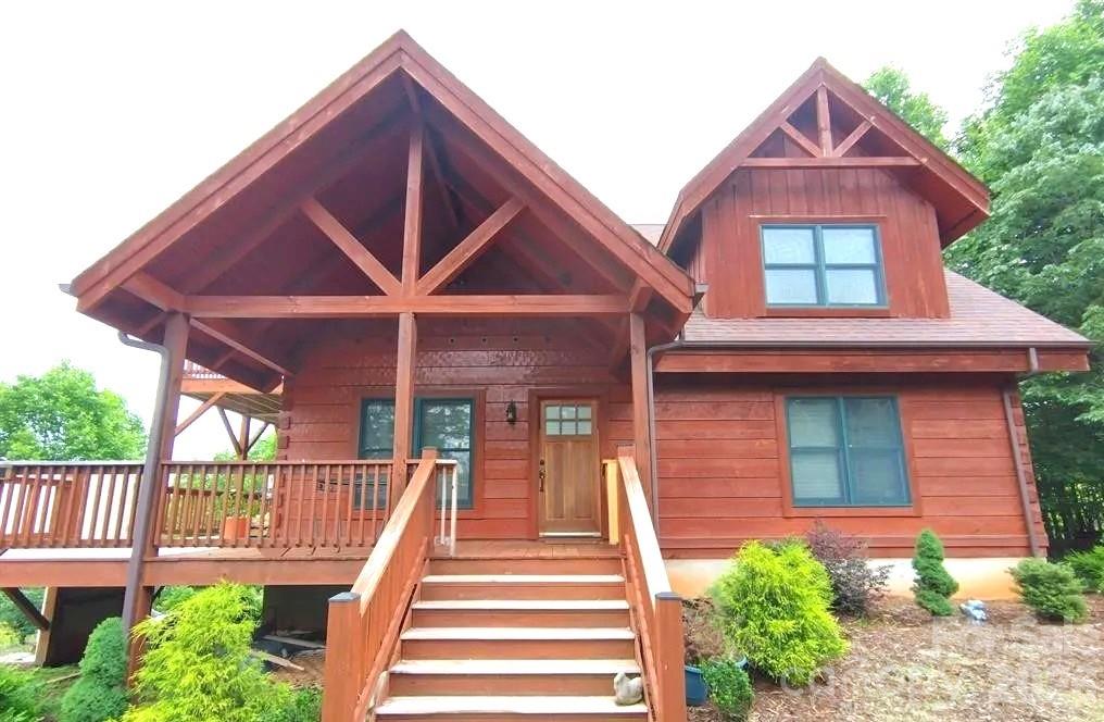 So much more to this property than meets the eye! The smell of the logs with light streaming into every room immediately triggers your senses. Indoor plants love the bright open light, with potential for indoor gardening in the loft, or on the sun filled decks that distract with beautiful views, sunrise or moonrise. Upstairs next to the open loft is a large primary bedroom with walk-in closet & ensuite bath. On the main level there is another primary and 2nd bedroom & full bath. The living, dining & kitchen are open flow with sliders to wrap around decks. 2.39 acres afford plenty of room for gardening & even a guest cabin. The 2 car garage is surrounded by 20 yr old landscaping & Murray Cypress line the roadway for privacy. The cabin is Powell built, air & water tight through all weather conditions. The wood stove keeps the cabin cozy in winter, plus a heat pump for heat and AC. Downstairs is a nearly completed apt, big laundry room & storage, plumbed & wired for bath & kitchen; with sliders to a patio & fenced yard. There is also a wheelchair lift for handicap access. Grandview Peaks Subdivision Offers Exclusive Access to a Private Lake, Beach, Pavilion, Play Area and Hiking Trails; and is only 11 Miles to Lake James. A MUST SEE!