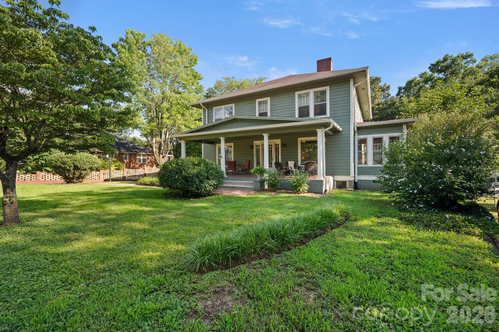Step back in time with this stunning 1923 historic home, originally owned by one of Glen Alpine's local physicians. Offering 5 bedrooms, 2.5 bathrooms, and over 3,000 heated square feet, this timeless residence blends vintage charm with modern updates, all situated on a 0.86-acre lot with a spacious fenced backyard.

The main level features a welcoming living room with an adjoining sunroom, a formal dining room perfect for entertaining, and a versatile bedroom that also makes an ideal home office or flex space. Large windows fill the home with natural light, while original hardwood floors, unique lighting fixtures, built-in storage, and period details showcase the craftsmanship and character rarely found in today's homes.

Upstairs, you'll find four additional bedrooms, including a spacious primary suite with a private bath, providing plenty of room for family and guests.

Outside, enjoy relaxing on the inviting front porch, entertaining on the expansive rear deck, or taking advantage of the detached two-car garage for vehicles, hobbies, or a workshop. The unfinished basement offers abundant storage, while the fenced backyard extends into a beautiful wooded area, creating both privacy and room to explore.

Recent improvements include a new roof on the home, a new roof on the detached garage, and oversized gutters, offering added value and peace of mind.

If you've been searching for a home with rich history, timeless character, generous living space, and thoughtful updates, this Glen Alpine gem is one you won't want to miss. Schedule your private showing today before this rare opportunity is gone!