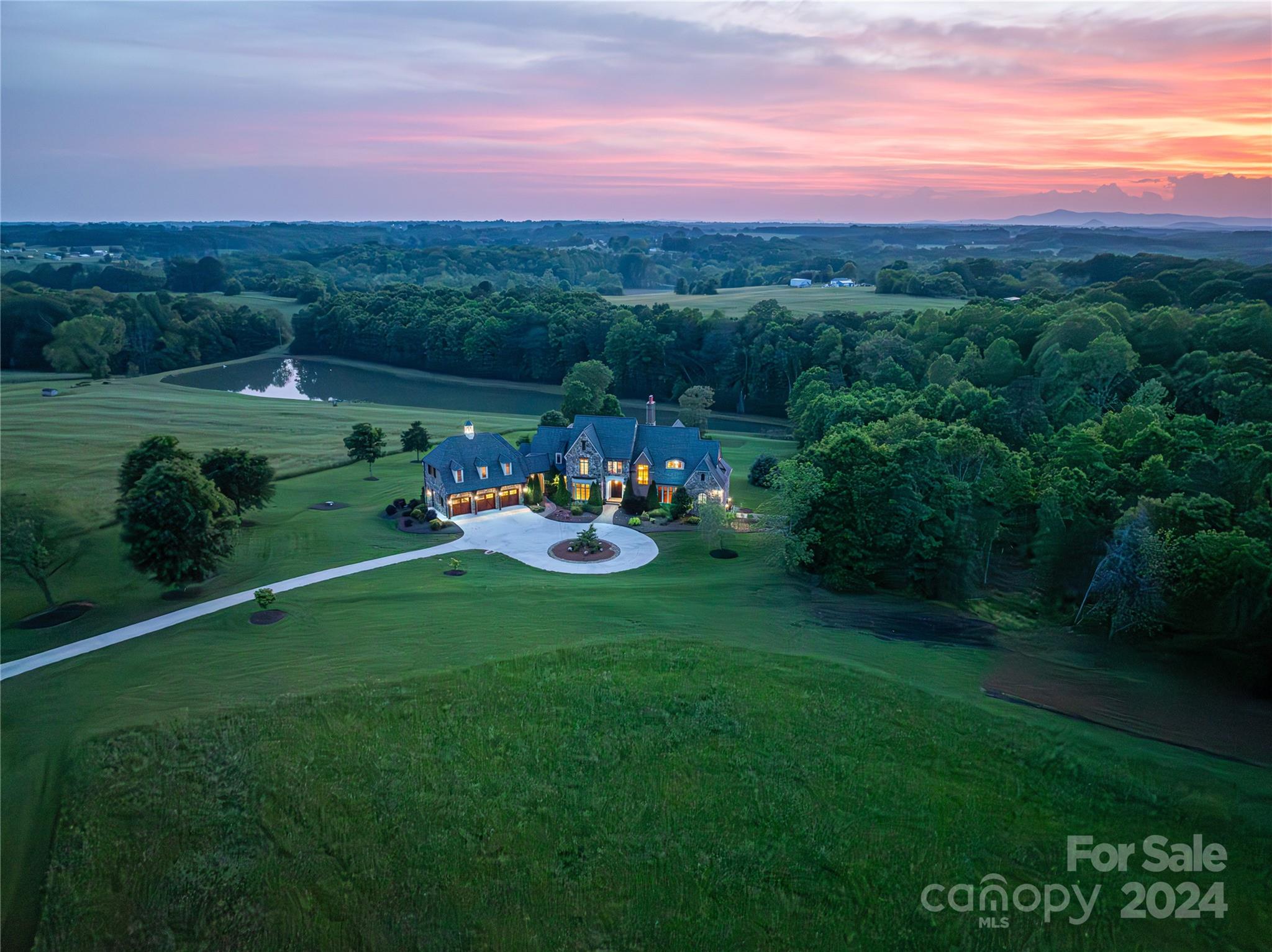 The Pinnacle of Luxury Living in Vale, NC! This Expansive French Provincial Estate spans over 13,000sq ft under roof  with 8,456+/- sq ft finished, nestled on 20+ acres of picturesque land. Featuring 5 BRs & 7.5BAs! Exquisite craftsmanship is evident with TN & VA Fieldstone Exterior, Oversized Walnut Creek Tumbled Brick, Crab Orchard Variegated Flagstone. Custom Gothic Arch Front door, the grand 2-story living room is the perfect place to entertain guests and business clientele, with solid wood beams and a stunning Italian Lecce Limestone fireplace mantel. Recessed Alder Wood Study offers a refined workspace, while the downstairs boasts a media room with a Mitsubishi Projector and retractable screen, Exercise Room. Main & 2nd Level laundry, Outdoor Kitchen, Screened Deck overlooking the neighboring pond. Would make a beautiful Wedding Venue, Equestrian Estate, or Private Retreat. Only an hour to Tryon Int'l Equestrian Center & 50 mins to Clt Airport. No HOA! Too many features to list!