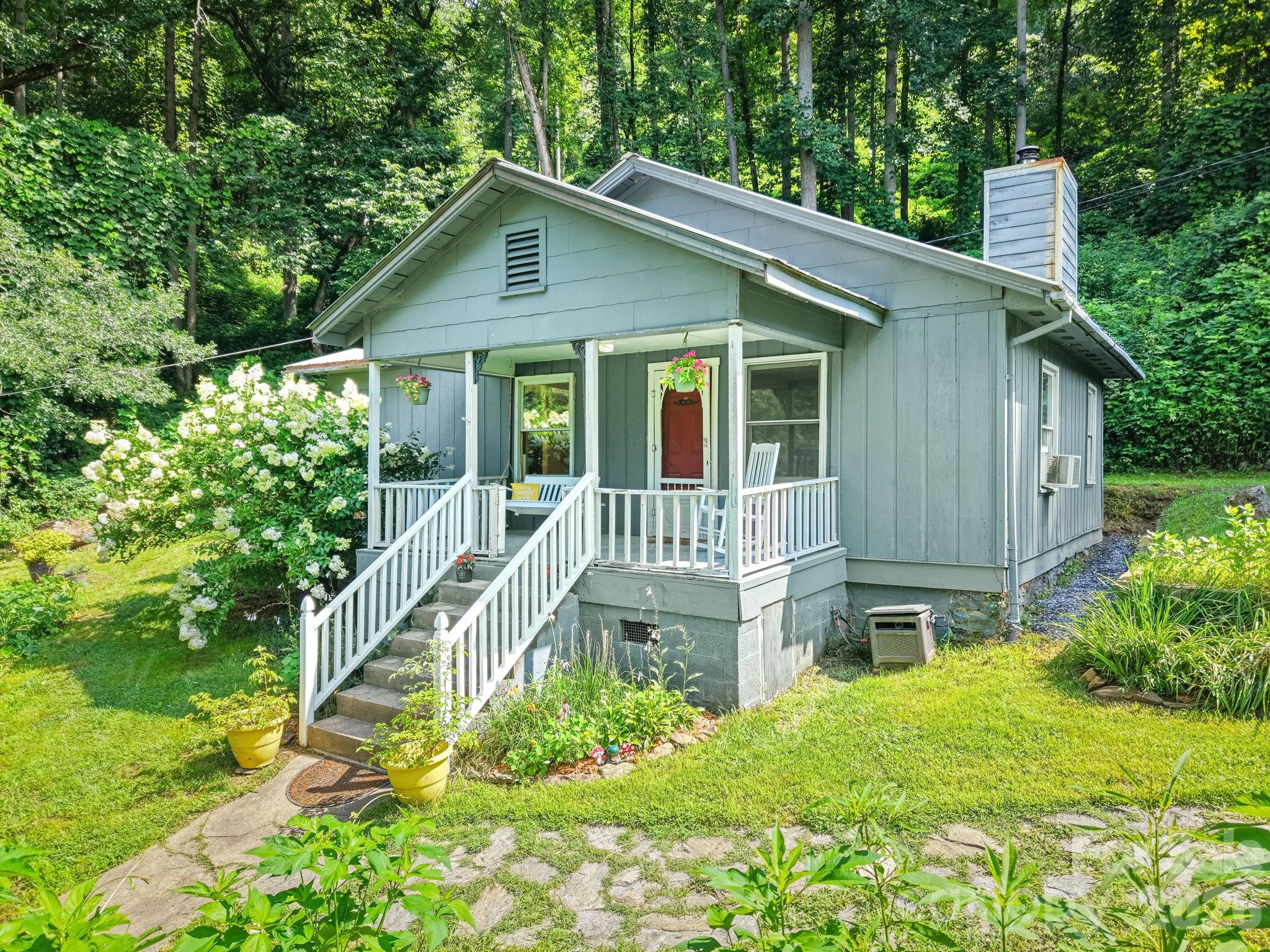 Open House Sunday 7/12/26 12-2 pm. Great things come in small packages! Escape to your own mountain retreat with this charming 2-bedroom, 1-bath cabin nestled on just under an unrestricted acre in Sylva. Perfect as a full-time home, weekend getaway, or vacation rental, this property offers the rare combination of peaceful creekside living without the expense of flood insurance.
Enjoy easy access to beautiful Scotts Creek, just approximately 50 yards from the front porch, where you can fish, relax by the water, or simply enjoy the soothing sounds of the creek year-round. Inside, the open floor plan features fresh interior paint, a cozy wood stove, and a warm, inviting atmosphere ideal for mountain living.
Recent improvements include a brand-new septic system, providing peace of mind for years to come. The bathroom has a new shower insert that makes the room sparkle. Outside, you'll find established garden spaces, a welcoming fire pit for evenings under the stars, a large storage shed, and a separate woodshed to keep firewood dry and ready for winter. The classic rocking chair front porch is the perfect place to enjoy your morning coffee while taking in the peaceful surroundings.
With no restrictions, plenty of usable outdoor space, and a beautiful creek just steps away, this property offers endless possibilities for outdoor enthusiasts, homesteaders, or anyone looking to enjoy the best of Western North Carolina.