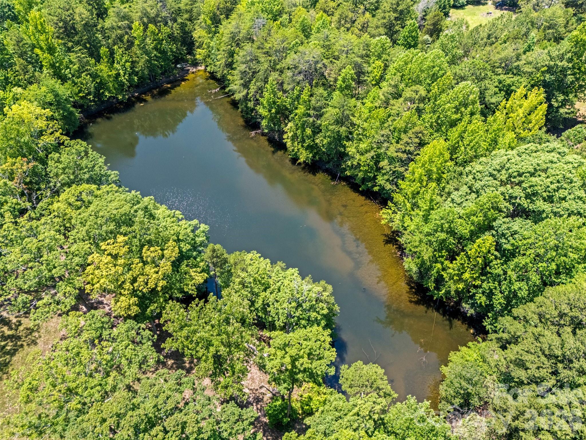 Rare opportunity to build your dream home on this stunning 12+ acre property featuring a beautiful mix of open pasture, mature hardwoods, a picturesque 1-2 acre pond, and black 4-board Kentucky fence along entire road frontage with 2 separate entrances. A gently elevated, cleared homesite overlooks the tranquil water, creating an exceptional setting for your custom home while offering outstanding privacy tucked away from the road.
The property also features a winding creek through the hardwoods, providing endless opportunities for walking trails, horseback riding, ATV trails, or simply enjoying the abundant wildlife and peaceful surroundings. Whether you're looking for a private country estate, hobby farm, or weekend retreat, this property offers the perfect combination of natural beauty and usable land.
An adjoining 2.8-acre parcel (2615 Highway 161 S) with an existing home is also available, offering the opportunity to own nearly 15 acres in total. The home is being sold as-is, with no value assigned to the residence.
Conveniently located just minutes from historic downtown York, Kings Mountain State Park, and only 15 minutes to I-85 with an easy commute to Charlotte. Located within the highly sought-after Clover School District, this is a rare opportunity to own one of York County's most scenic homesites. Please be sure to schedule with agent, surveillance cameras on property.