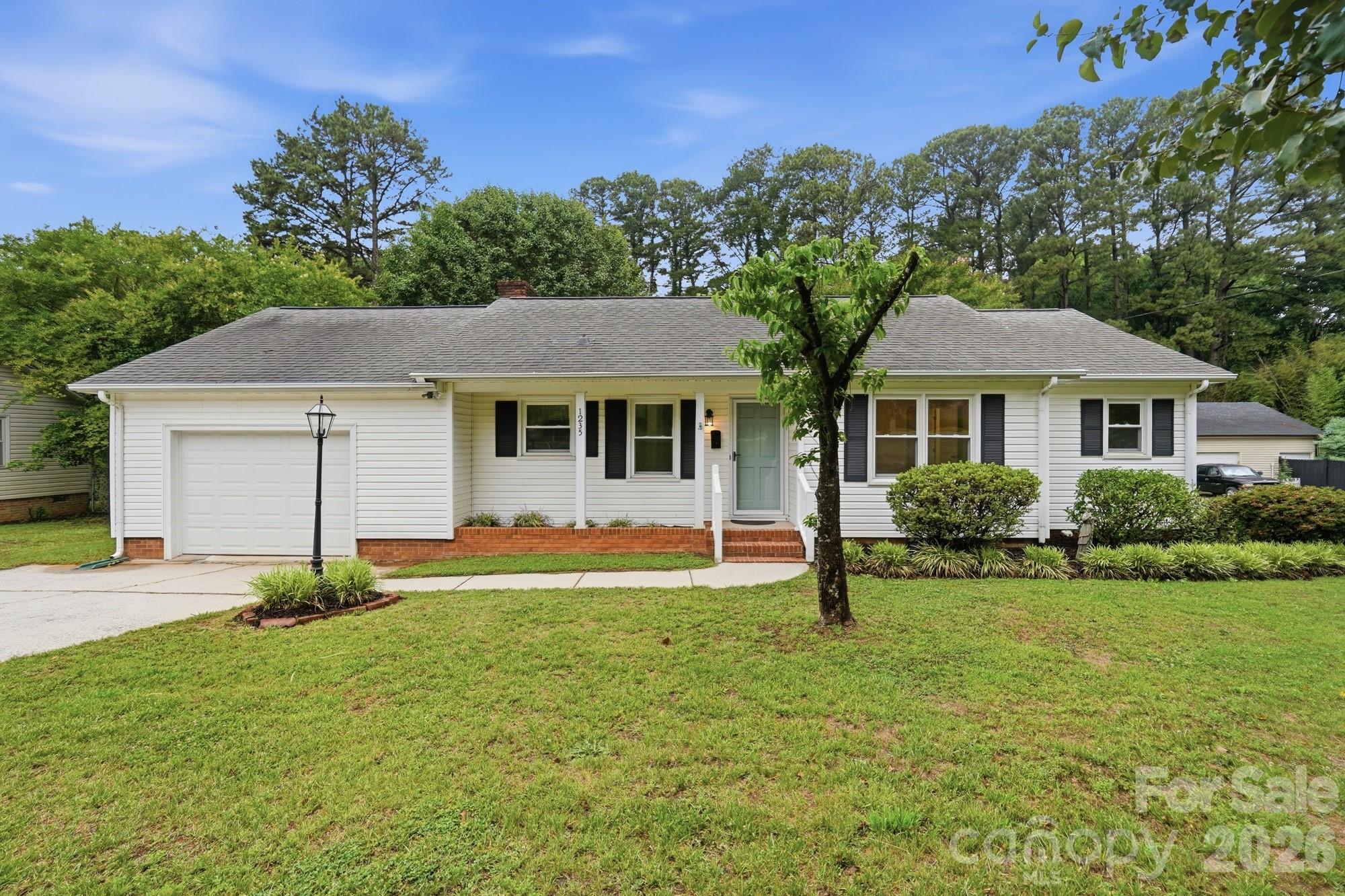 UPDATED and Ready for a new owner!!!  Freshly Painted, New Carpet, LVP and other updates to this home!!!  This Well-kept 3-bedroom, 1.5-bath home features a stylish kitchen with granite countertops and stainless steel appliances. Enjoy cozy evenings by the fireplace in the inviting living room. The spacious deck overlooks a flat, private backyard—perfect for entertaining or relaxing outdoors. A large garage offers plenty of storage and parking space. Conveniently located just minutes from I-85 and Highway 29, this home combines comfort, convenience, and charm in a move-in-ready package!