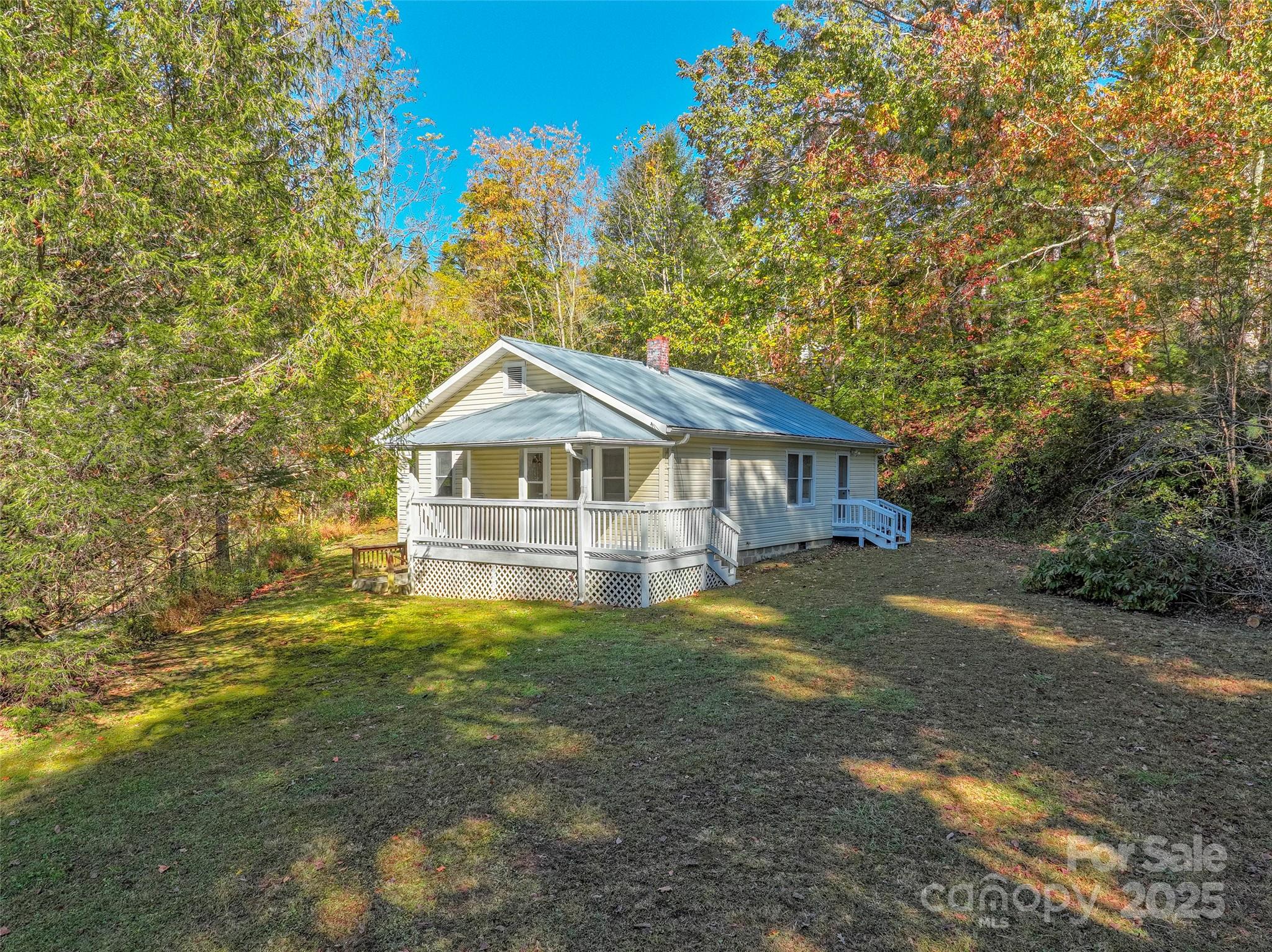 Discover the peaceful tranquility of Western NC with this charming 936 sq. ft. mountain cottage situated on approximately 4 acres less than 2 miles from downtown Spruce Pine. New survey recently completed. This cute cottage features a classic layout with 3 bedrooms, 1 bathroom, a cozy living room, functional dining room and a kitchen ready for your personal touch. The covered front porch invites you to slow down, sip your morning coffee & enjoy the sights & sounds of the surrounding woods. The property also benefits from a private spring water system. A full basement also provides additional storage. Approximately 1 hr to Boone or Asheville. 1 hr to Johnson City, TN. If you’re dreaming of a simpler lifestyle surrounded by nature this cottage is perfect for you.