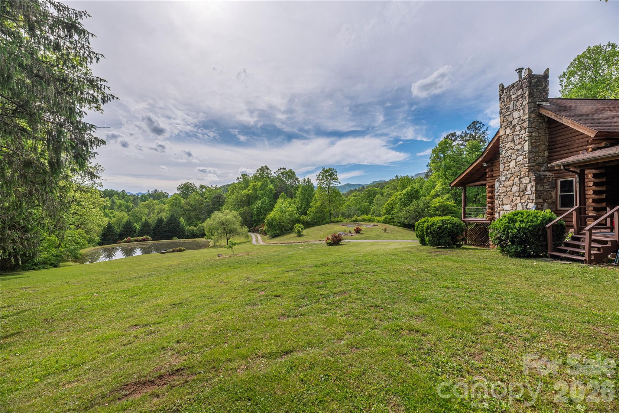 Escape to this charming log cabin nestled on beautiful acreage, offering the perfect blend of privacy and convenience. Located just 10 minutes to Sylva, 25 minutes to Waynesville, and approximately 30 minutes to Asheville, you’ll enjoy peaceful mountain living with easy access to shopping, dining, and recreation.
Step inside to find cozy cabin character and inviting living spaces designed for comfort. The bright breakfast area is the perfect spot to sip your morning coffee while taking in the serene views—a peaceful way to start every day.
With a creek-fed pond and plenty of outdoor space to explore, garden, or simply relax and enjoy nature, this property offers the mountain lifestyle you’ve been dreaming of. Ready for its second life, this charming cabin offers endless potential to make it your own while preserving the warmth and character that make mountain living and this home so special.