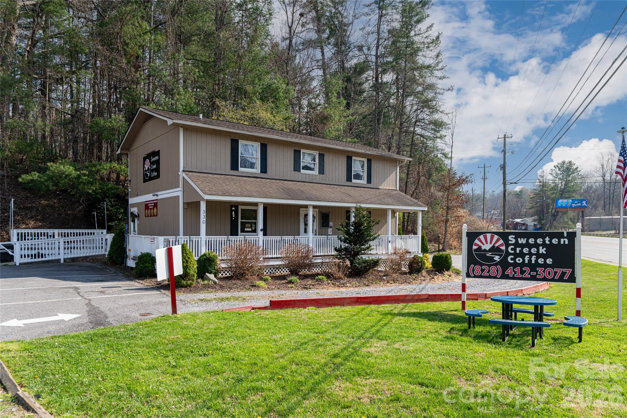 Just off Interstate 40 at Exit 51 along highly traveled Sweeten Creek Road, this mixed-use commercial property presents a compelling investment opportunity in one of South Asheville’s active growth corridors. With exposure to approximately 30,000 vehicles per day, the site benefits from strong visibility, consistent traffic patterns, and proximity to key employment and distribution hubs. The property is anchored by a fully built-out ground-level retail space operating as a coffee shop, offering flexibility for a variety of commercial uses, including food and beverage, office or service-oriented concepts. The existing improvements, equipment, furnishings, and fixtures provide a turnkey foundation that can be leveraged or repositioned depending on an investor’s vision. Above, a separately accessed two-bedroom, one-bath residential unit introduces a valuable income-producing component, currently utilized as a short-term rental. This upper-level space enhances the asset’s mixed-use appeal, offering the potential for continued rental income, long-term tenancy, or live/work functionality. Additional site features include approximately 25 dedicated parking spaces and an on-site billboard generating supplemental revenue, further strengthening the property’s diversified income profile. Its strategic location near Biltmore Village, major transportation routes, and regional employers supports performance and future upside. An exceptional opportunity for investors seeking a flexible mixed-use asset with multiple income streams, strong fundamentals and long-term positioning in the South Asheville market.