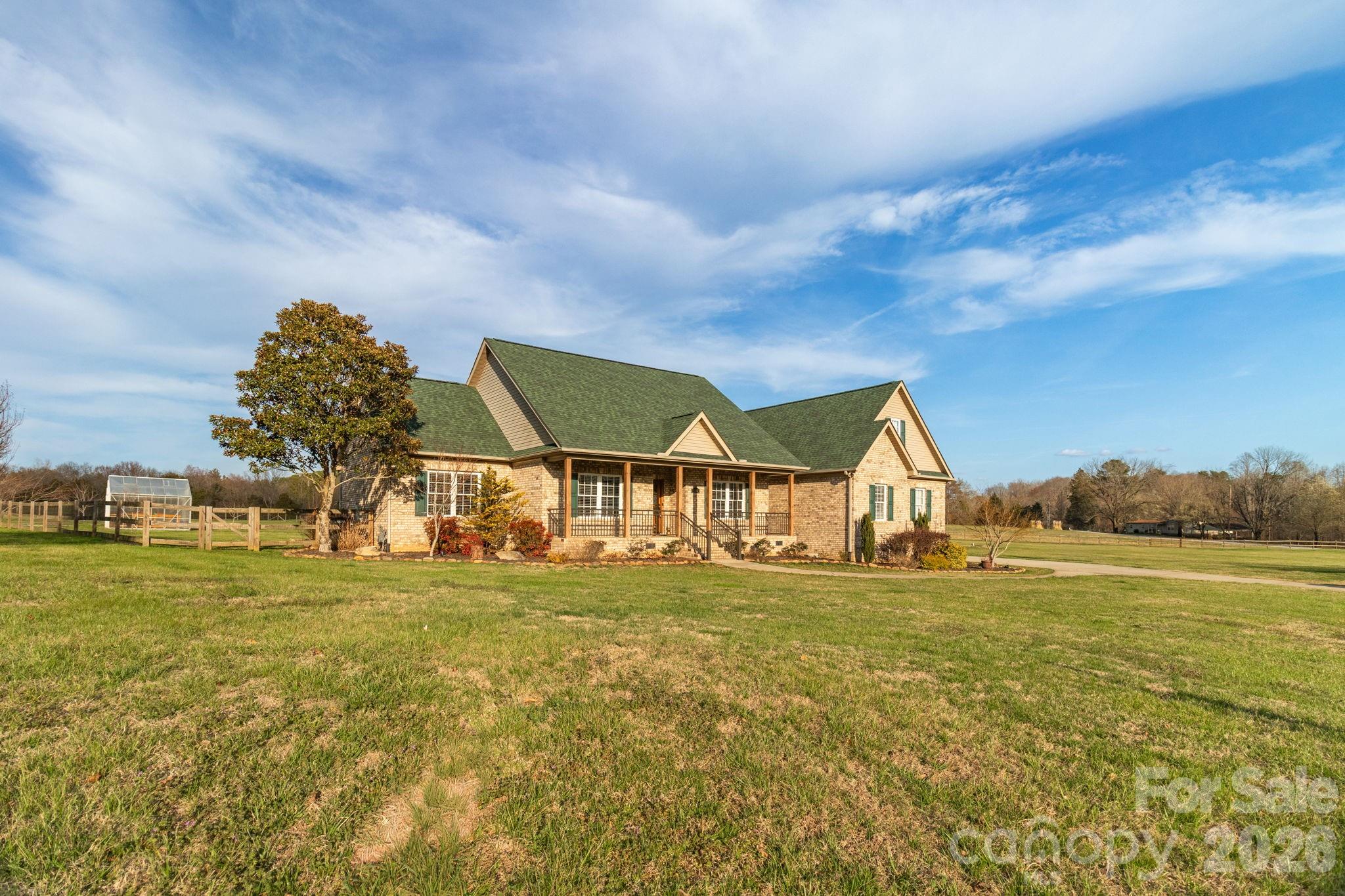 Country living meets luxury in this beautifully renovated home on 3 acres! The spacious living room features a vaulted shiplap ceiling with exposed beams and a gas log fireplace. The open-concept kitchen offers custom cabinetry, granite countertops, stainless steel appliances, custom tile, pantry, and breakfast area. Formal dining showcases a tray ceiling with woodwork, beadboard, and picture rail molding, continuing into the home office. The primary suite includes a spa-like bath with dual granite vanities, tiled shower, and walk-in closet with built-ins. Two additional bedrooms have private baths. Bonus room with half bath above garage. Enjoy outdoor living with two covered porches, deck, patio, pergola, and a 24x36 barn with sheds. Schedule your showing today!