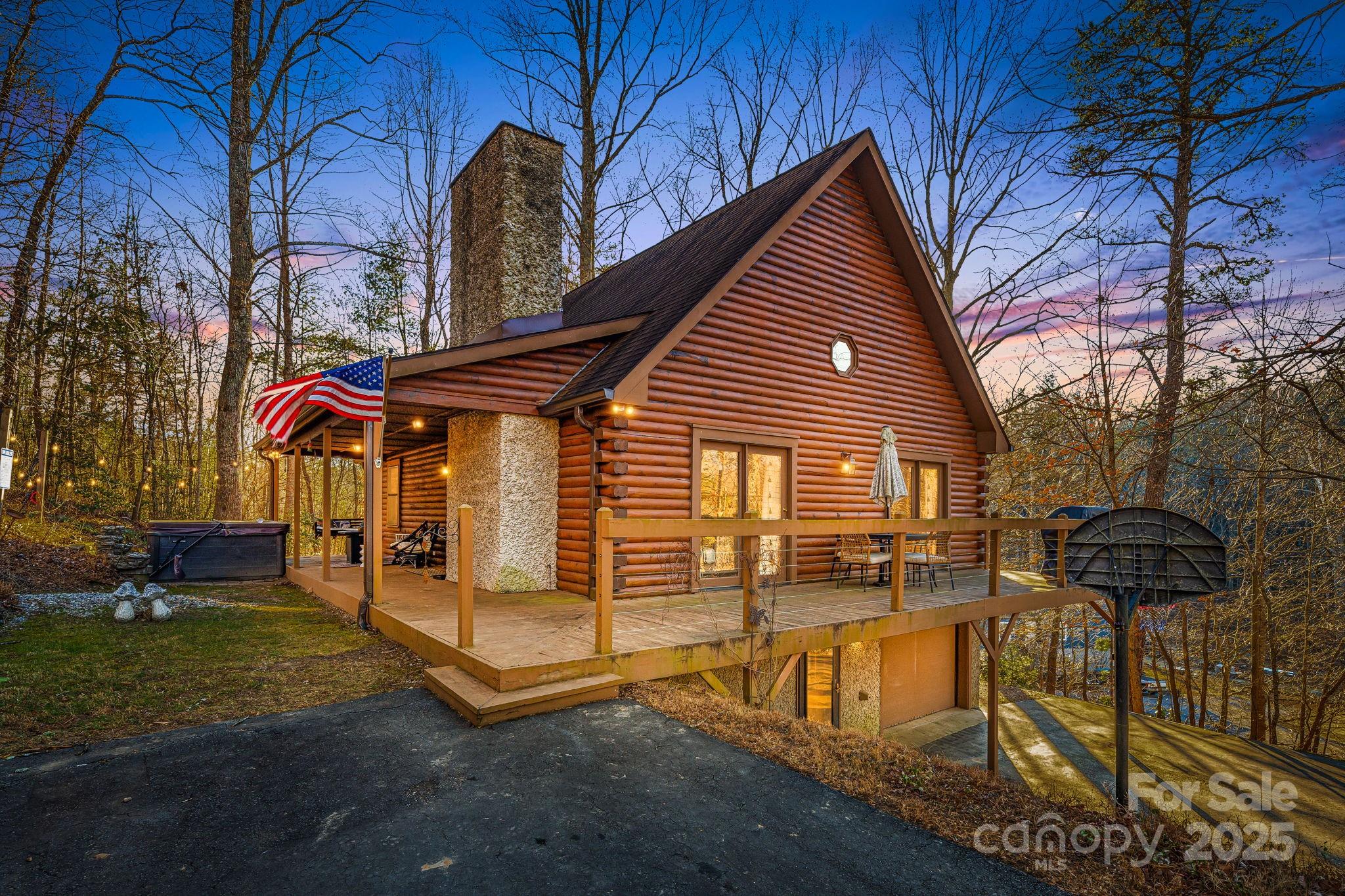 Beautiful Yellow Pine Log Cabin in Fairview, offering both timeless rustic charm and proven short-term rental success. Set in a private, secluded location yet just a short drive to Asheville, local breweries, and the Blue Ridge Parkway, this property provides the perfect balance of peaceful retreat and convenient access to area attractions. The home features new vinyl plank flooring throughout most of the cabin, complementing the warm log construction and modern updates. The open-concept living area includes a cozy fireplace, ideal for chilly mountain evenings, while the kitchen offers ample counter space for cooking and entertaining. With three bedrooms plus an additional bonus/sleeping area and two full bathrooms, the layout is well-suited for both personal use and guests. Outdoor living is a highlight, with front and side decks overlooking the natural surroundings and a hot tub for relaxing year-round. The lower level includes a second gathering room with games for all ages, creating additional space for entertainment and guests. Additional features include an EV connection in the garage and easy access to outdoor recreation, with the Blue Ridge Parkway just a couple of miles away. Make your appointment today!