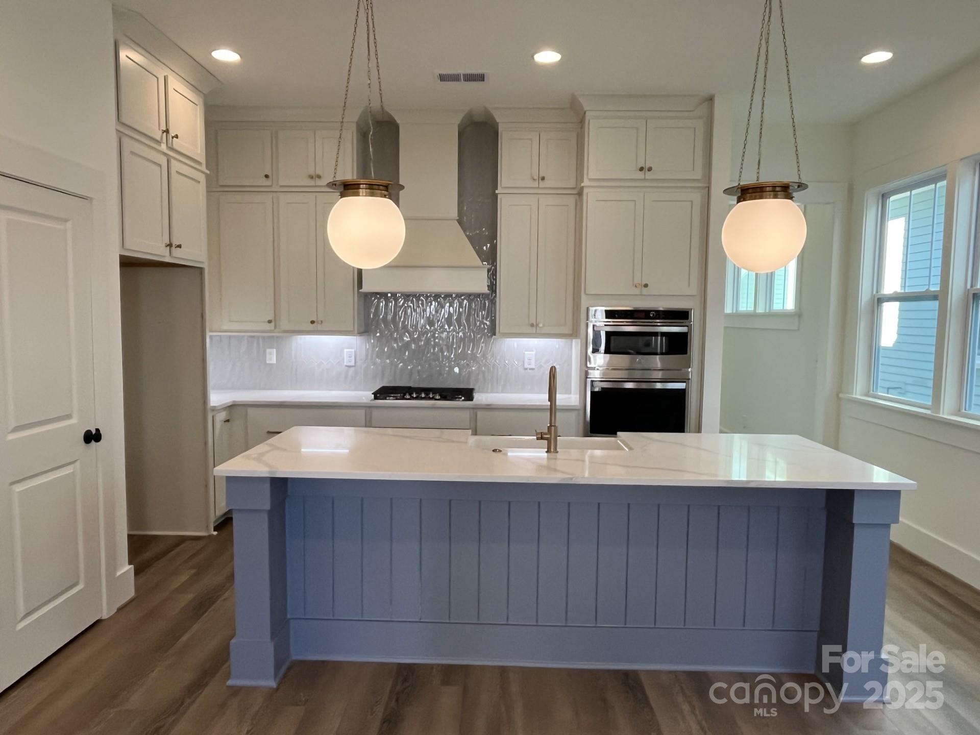 This charming Cottage is conveniently located in Springfield Town Center where you can enjoy walking to local area restaurants, shops and the Harris Teeter. Features on the main level include open living with the family room leading into a beautiful kitchen with a large center island. The primary bedroom on the lower level leads out to a beautiful covered rear porch perfect for entertaining. Or choose to relax on your upper level front porch overlooking the center courtyard in the community. The upper level features two spacious bedrooms each with a walk-in closet plus two full baths. There is an additional loft space perfect for entertaining or that fourth bedroom if needed. The walk out storage is easily accessible for all of your storage needs. You don't want to miss this opportunity to own a brand new home in Fort Mill!
