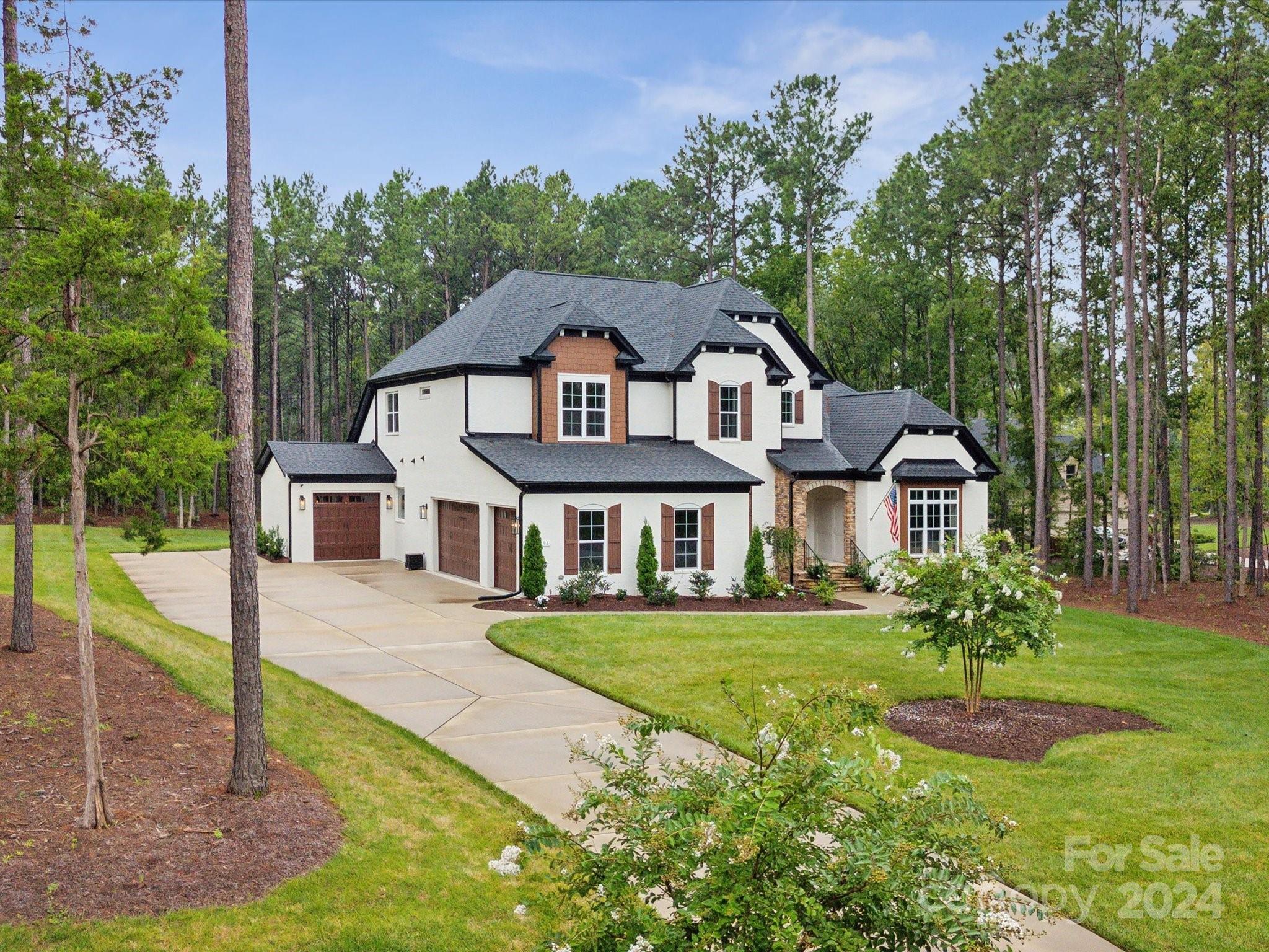 Welcome home to this custom beauty all brick French European inspired estate nestled on 1.49 acres in the forested gated community of Riverchase Estates! This 4 bed/3.5 bath +office +bonus/media +4-car garage includes solid oak hardwood floors, marble kitchen tile backsplash, landscape lighting, speciality limewash paint as accents, custom built-ins, & 16ft slider doors leading to outdoor covered flagstone patio w/ 2nd fireplace surrounded by mature pines. Open concept spacious Great Room to Kitchen w/ oversized kitchen island, wet bar w/ wine fridge, large walk-in pantry. Big windows throughout offer natural light from every angle. Primary Suite w/ two walk-in closets & oversized soaking tub. Exclusive access:$5m amenities center w/ resort-style pool, tennis/pickelball/basketball courts, playground, clubhouse/fitness center & more! Explore nearby Catawba River for kayaking & take a stroll through wooded trails of the nature preserve. Close proximity to Ballantyne, Indian land, I-77.