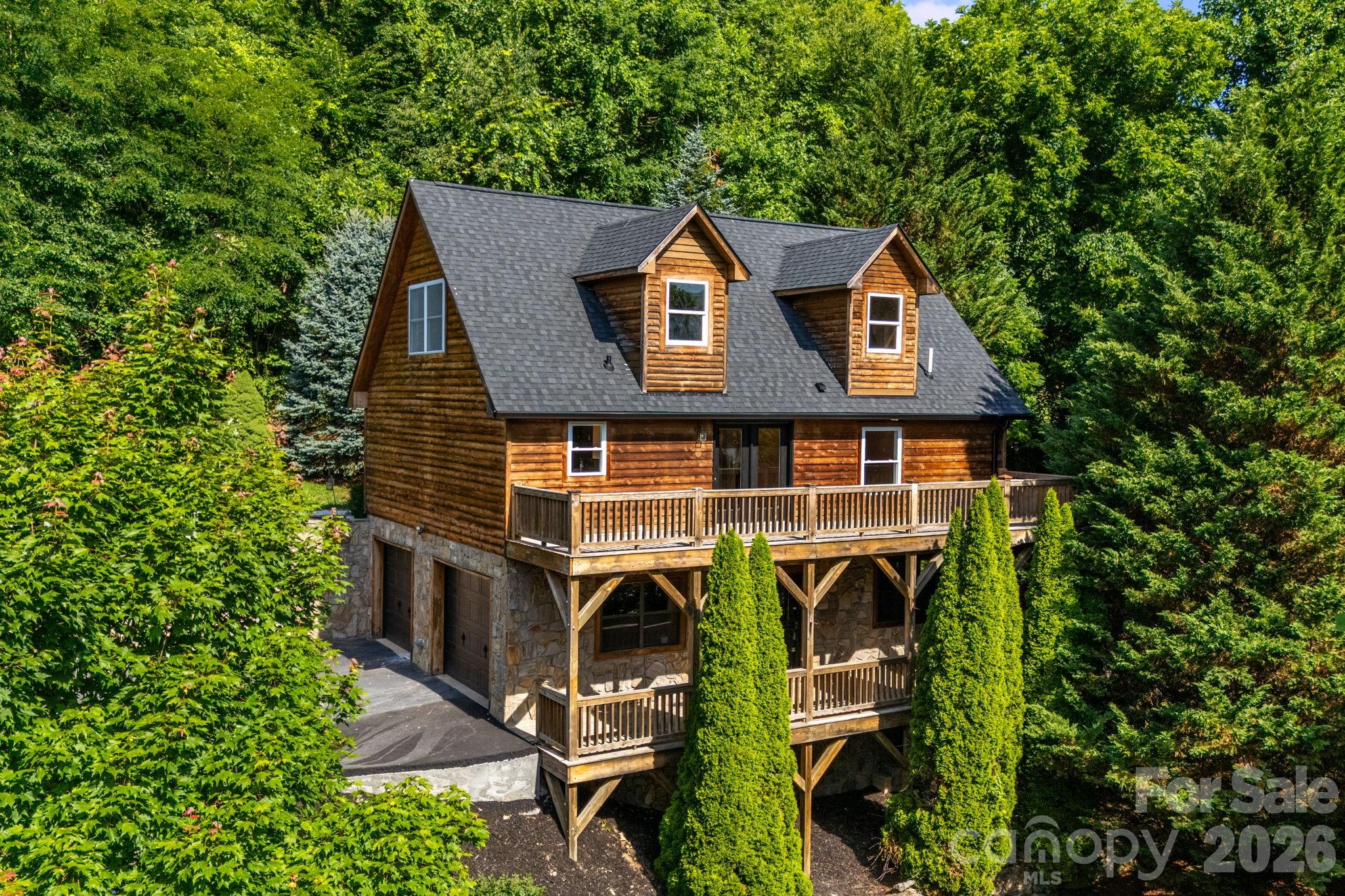 Wake up to stunning year-round mountain views at 88 Mayflower Court! Tucked on 2.25 acres, this charming 3-bedroom, 2.5-bath mountain home offers the perfect blend of comfort, space, and scenery. Inside, enjoy 1,768 square feet of inviting living space featuring a cozy gas log fireplace, dedicated dining area, and a warm, welcoming layout. Step outside onto one of two expansive decks—ideal for morning coffee, evening sunsets, or simply taking in the peaceful mountain surroundings.
The spacious unfinished basement opens the door to endless possibilities, whether you envision a workshop, game room, home gym, or additional living space. A storage outbuilding and beautiful landscaping add even more function and charm. Located just minutes from downtown Waynesville, Lake Junaluska, and Maggie Valley, this property delivers the mountain lifestyle buyers are looking for—whether as a full-time residence, second home, or peaceful getaway. Don’t miss the chance to make this mountain retreat yours!