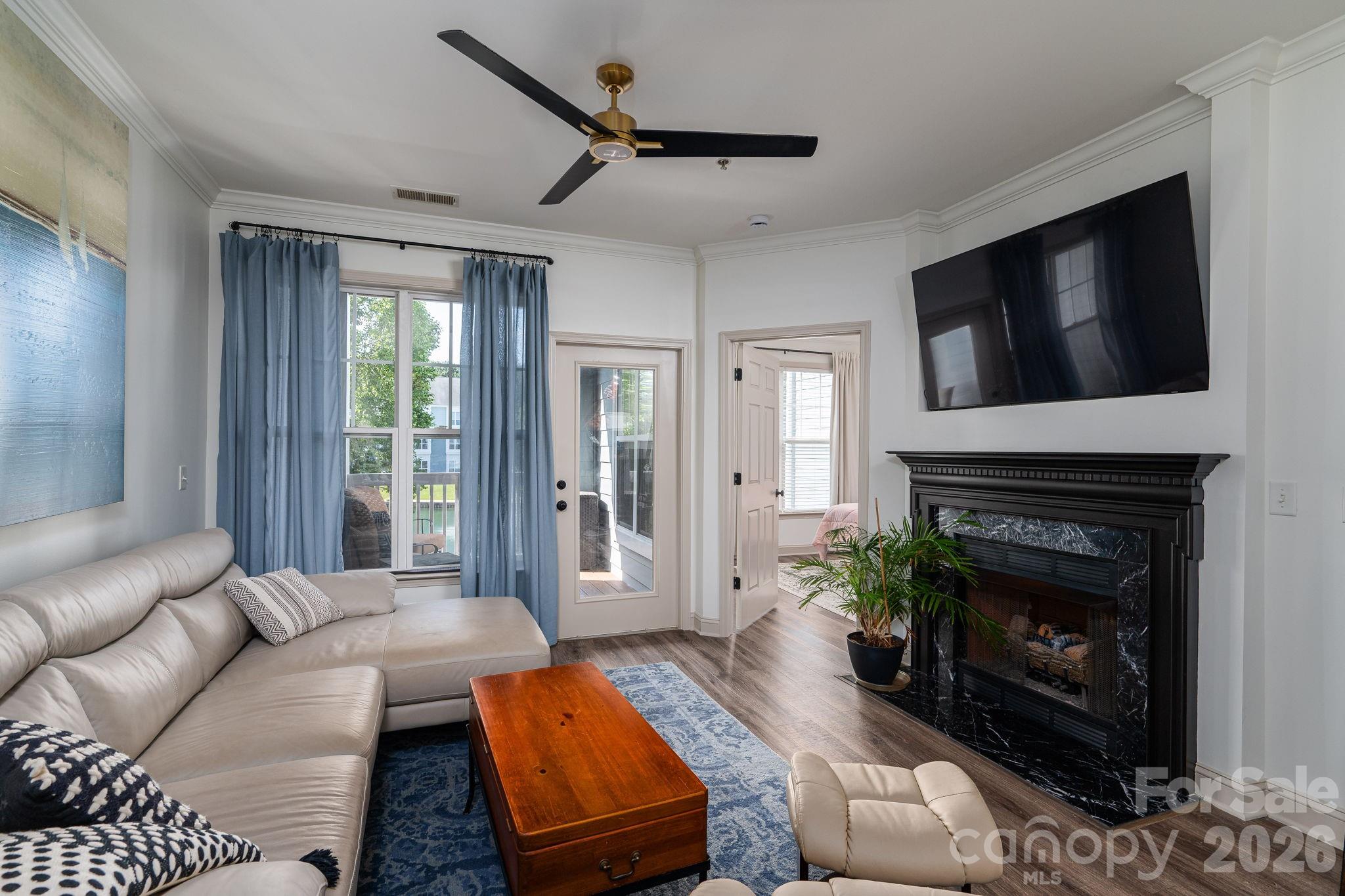 Experience this totally renovated condo with beautiful and serene views of the pond. The spacious kitchen offers two-tone cabinets with beautiful quartz countertops that spans up on the backsplash. Along with the rich, color on the wall, new cabinetry and tile give each bathroom a feel of ultra luxury. New Crown and base mold, new lighting,  and a serene color palette, finish the elegant look.  The gas log fireplace offers an extra form of heating during the winter and a nice ambiance anytime. The outdoor covered porch, looking directly at the pond fountain, offers new, no maintenance, composite decking. Near shopping, restaurants, highways, parks, and Lake Norman, this property offers the perfect location for all your needs. Don't forget to bring your pickle ball/tennis racket, then afterwards lounge by the community pool.  A work-out room tops off a list of amenities.Water and Sewer included in HOA dues. Agent is owner of property.