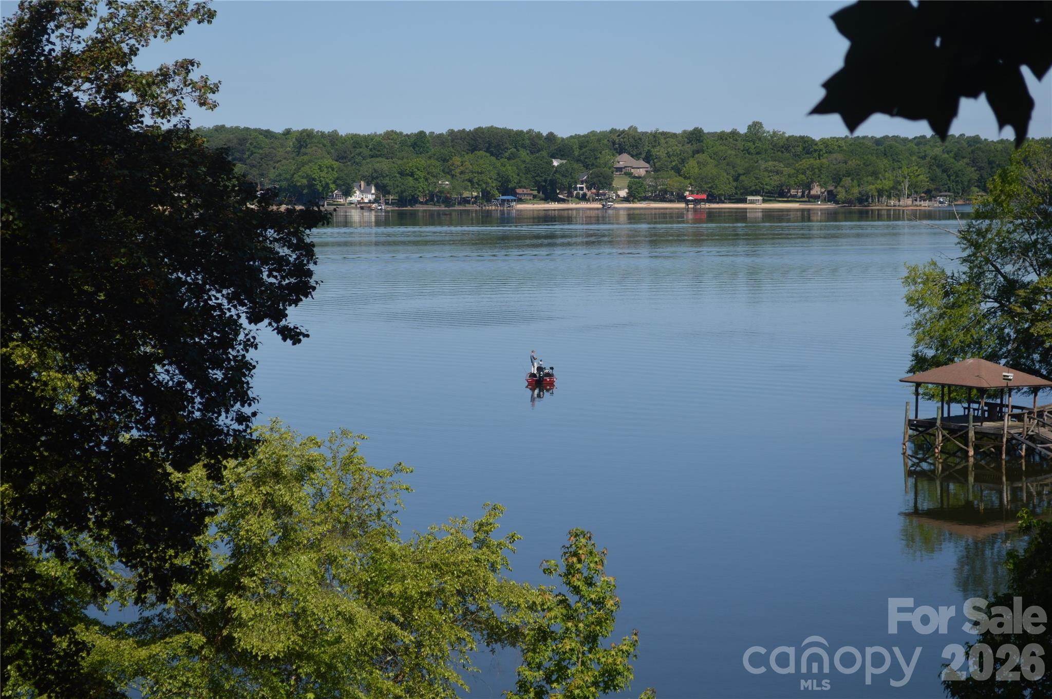 If you have been searching for a lake property that is located with some of the most spectacular views and location on Lake Wylie you have found it.  Whether you are interested in having a location you can run out to on weekends, building your dream home on a great waterfront property with gorgeous views located in the Southwest corridor of Charlotte, you have found your home!
Located directly beside the Palisades master planned community which is home to The Palisades Country Club boasting a Jack Nicklaus Design Golf Course with a tremendous tennis, swim, fitness and pickleball complex, and walking trails throughout. The best part of this waterfront home and location is that you have the opportunity to join the country club without having HOA restrictions. If you love boating, the home has an entire corner of main channel views and the dock is situated on the side along a cove so your views are unobstructed.  If you are looking for the perfect investment in waterfront property, come visit and see the home!