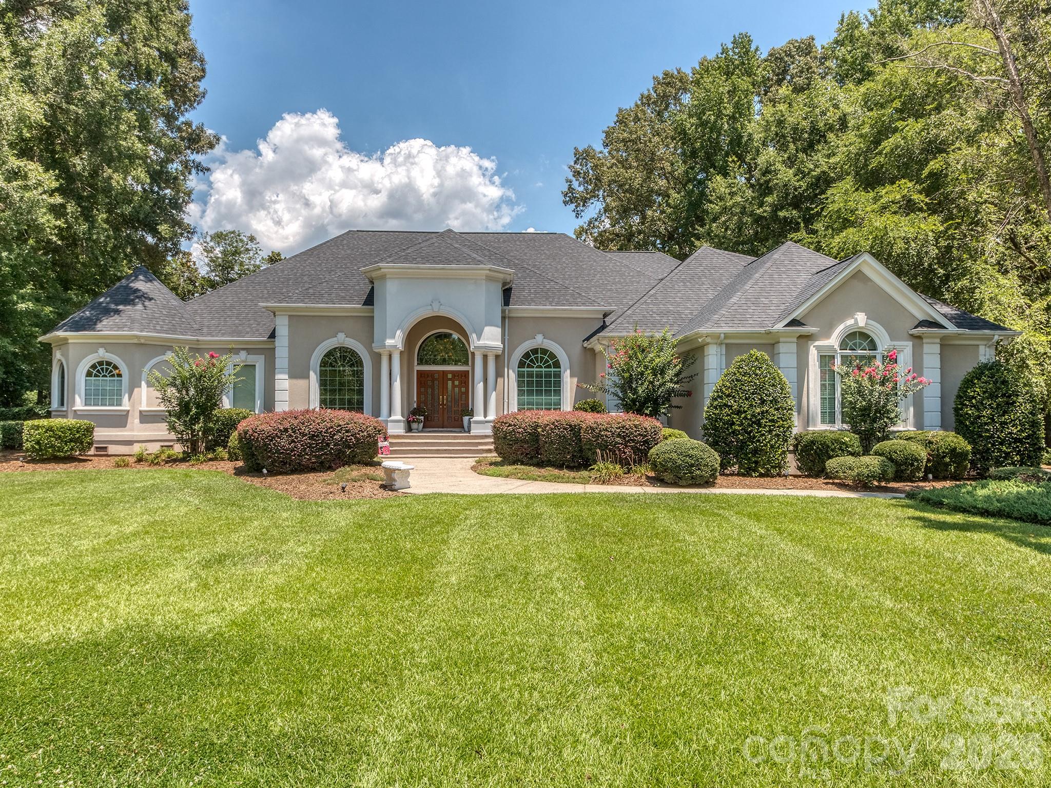 Located in the beautiful Walden Pond community and situated on a private, wooded 1.31-acre lot, this 4 bedroom, 3.5 bathroom home offers over 4,200 square feet of comfortable living space with a functional layout and timeless design.

The main level features soaring ceilings, hardwood floors, a dedicated office, formal dining room, spacious family room, and a kitchen with premium appliances and generous workspace. The primary suite is conveniently located on the main floor and includes a sitting area, updated bathroom, custom twin walk-in closets, and access to the private screened porch. Upstairs you'll find three additional bedrooms, and plenty of storage to include a walk up attic.

Outside, the private backyard is thoughtfully designed for relaxing and entertaining with a pool and spa, covered outdoor kitchen, in-ground gas fire pit with built in seating, covered porch, and mature landscaping that provides exceptional privacy.

Recent updates include fresh interior paint, new carpet, new roof installed last year, stucco professionally inspected with recommended repairs completed, and the septic system recently pumped, providing added peace of mind.

Walden Pond is a well-established community with walking trails, a community pond, and a quiet setting while remaining just minutes from shopping, dining, and everyday conveniences. Located in the Marvin school district