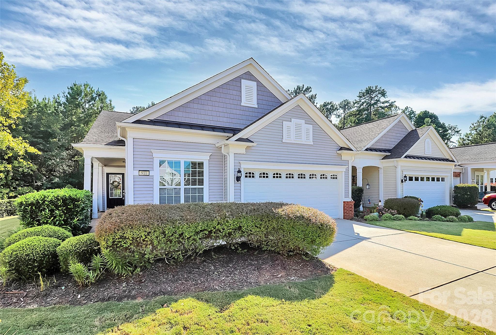Refined Living in Sun City Carolina Lakes

Welcome to an exceptional opportunity to embrace elegant, low-maintenance living in one of the most coveted enclaves of Sun City Carolina Lakes. Perfectly positioned at the end of a quiet cul-de-sac, this beautifully maintained end-unit villa offers a rare combination of privacy, sophistication, and serene natural surroundings.

Set against a peaceful wooded backdrop with no direct rear neighbors, this residence invites you to unwind in your own private retreat. Enjoy tranquil mornings with coffee on your secluded patio, where nature provides a calming backdrop year-round. Despite its quiet setting, the home remains conveniently close to the Lakehouse and the community’s premier amenities—just a short, scenic walk away.

Inside, the home exudes warmth and understated elegance. Thoughtful updates enhance both form and function, including rich hardwood floors in the kitchen and dining area, fresh designer paint throughout, and new carpeting in the office. The well-appointed kitchen flows effortlessly into a light-filled sunroom, creating a versatile living space ideal for entertaining, relaxing, or enjoying quiet moments at home.

The thoughtfully designed single-level layout offers both comfort and flexibility, featuring two generously sized bedrooms. The owner’s suite is a private sanctuary, complete with an ensuite bath designed for both comfort and convenience. A dedicated office provides the perfect space for remote work, creative pursuits, or accommodating guests.

Additional highlights include an attached two-car garage with ample storage, ensuring both practicality and ease in everyday living.

This home is complemented by a truly effortless lifestyle. The HOA provides exterior maintenance, roof care, and lawn service, allowing you to enjoy a lock-and-leave experience with confidence and peace of mind.

As a resident of Sun City Carolina Lakes, you’ll enjoy access to a premier 55+ active adult community offering world-class amenities—including golf, fitness centers, walking trails, social clubs, and a vibrant calendar of events. Every day presents a new opportunity to connect, explore, and live fully.

This is more than a home—it’s a refined lifestyle defined by comfort, convenience, and quiet luxury.