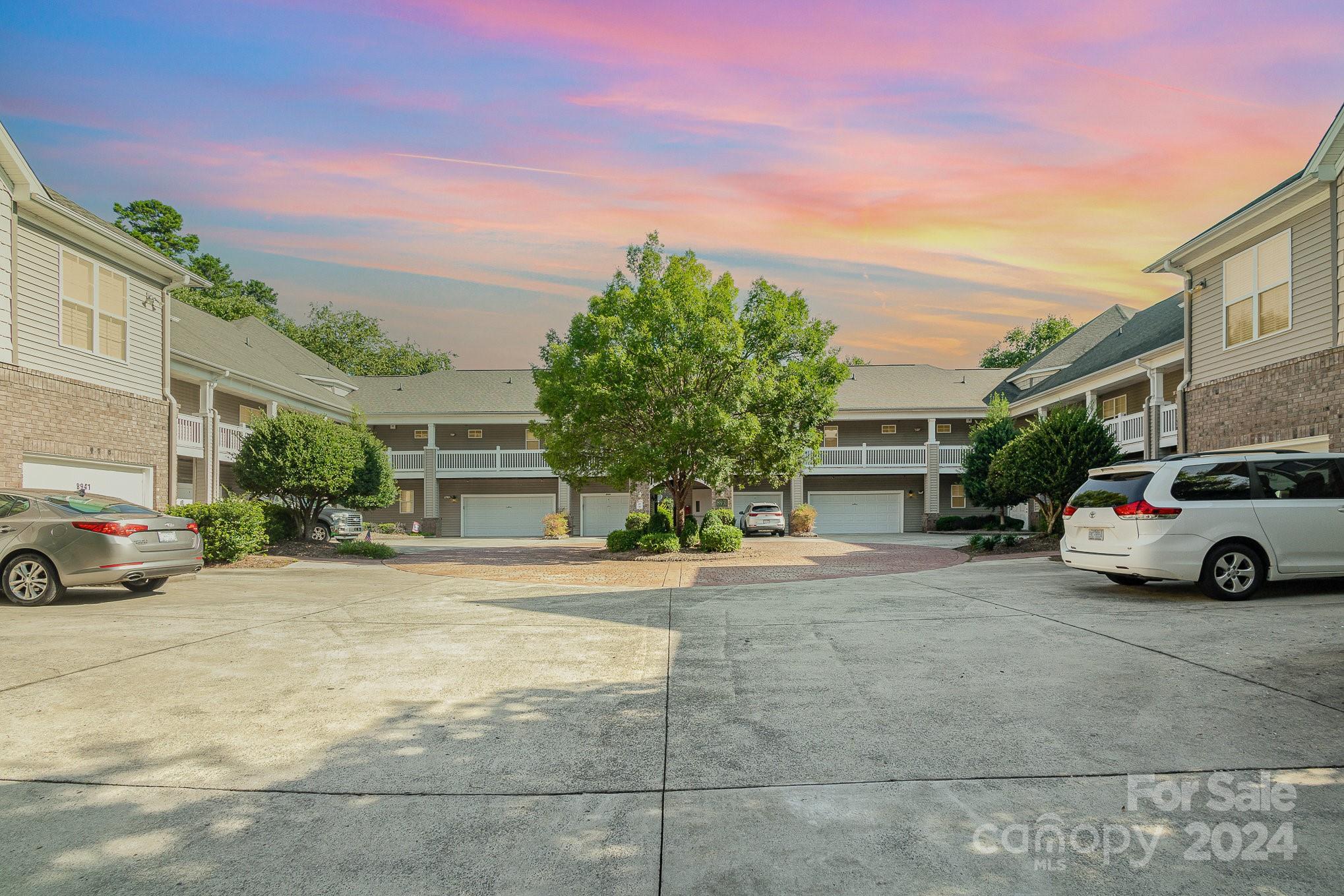 Nestled in the heart of Cornelius, this charming 3-bed/2-bath condo features a spacious 1-car garage & a generous, covered wrap-around porch. The European Courtyard-style building offers single-level living at its finest! The interior is enhanced with neutral paint, updated flooring, lighting & HVAC system, all complementing the open floorplan that is bathed in natural light. The kitchen is well-appointed with ample cabinets, counter space & pantry. The dining area showcases a new light fixture, while the living room is designed for comfort with a ceiling fan, gas fireplace, and direct access to the covered porch. The primary bedroom is a retreat, featuring a tray ceiling, ceiling fan, large walk-in closet, and a private bathroom with dual sinks, a jetted tub, and a separate shower. Two additional bedrooms share a full bath with a tub/shower. The building also includes an elevator for added convenience. Community amenities include a pool, clubhouse & access to Greenway walking trails.