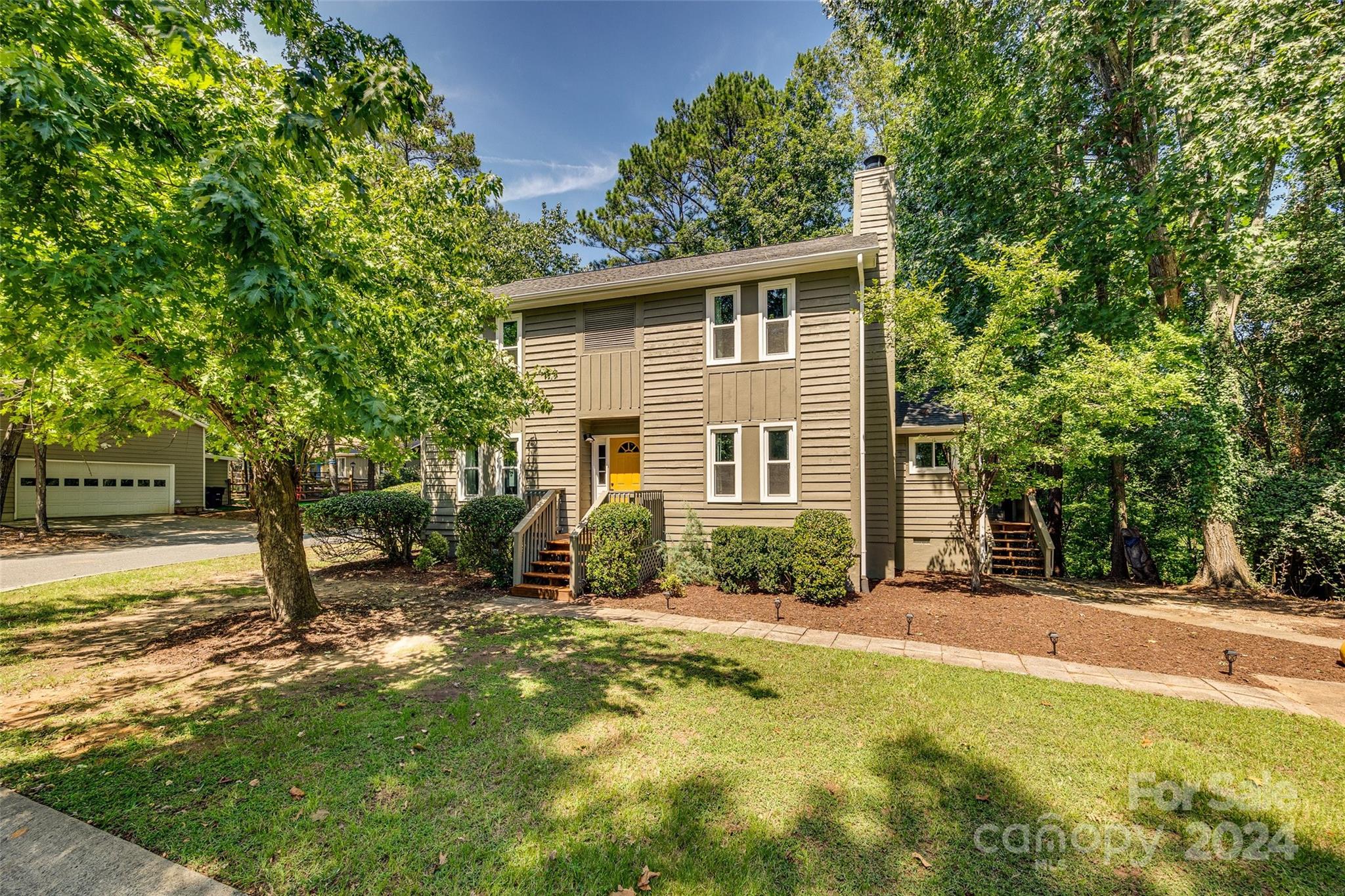 Adorable home in Tega Cay on Windjammer! This home has over $40,000 in recent updates which include brand new windows, new carpet upstairs, the interior and exterior have been painted, and brand new heat pump was installed November 2023.  This charming home features white kitchen cabinets with solid surface countertops and backsplash, a beautiful brick fireplace in the family room, hardwood floors throughout the main living area. The primary bedroom is spacious with walk in closet and the primary bathroom is bright and super cute with black and white tile.  Outside, enjoy a private, tree-lined lot with a screened porch.    This home has been well maintained and cared for and if you are a lake lover Windjammer Beach is close by for access to Lake Wylie