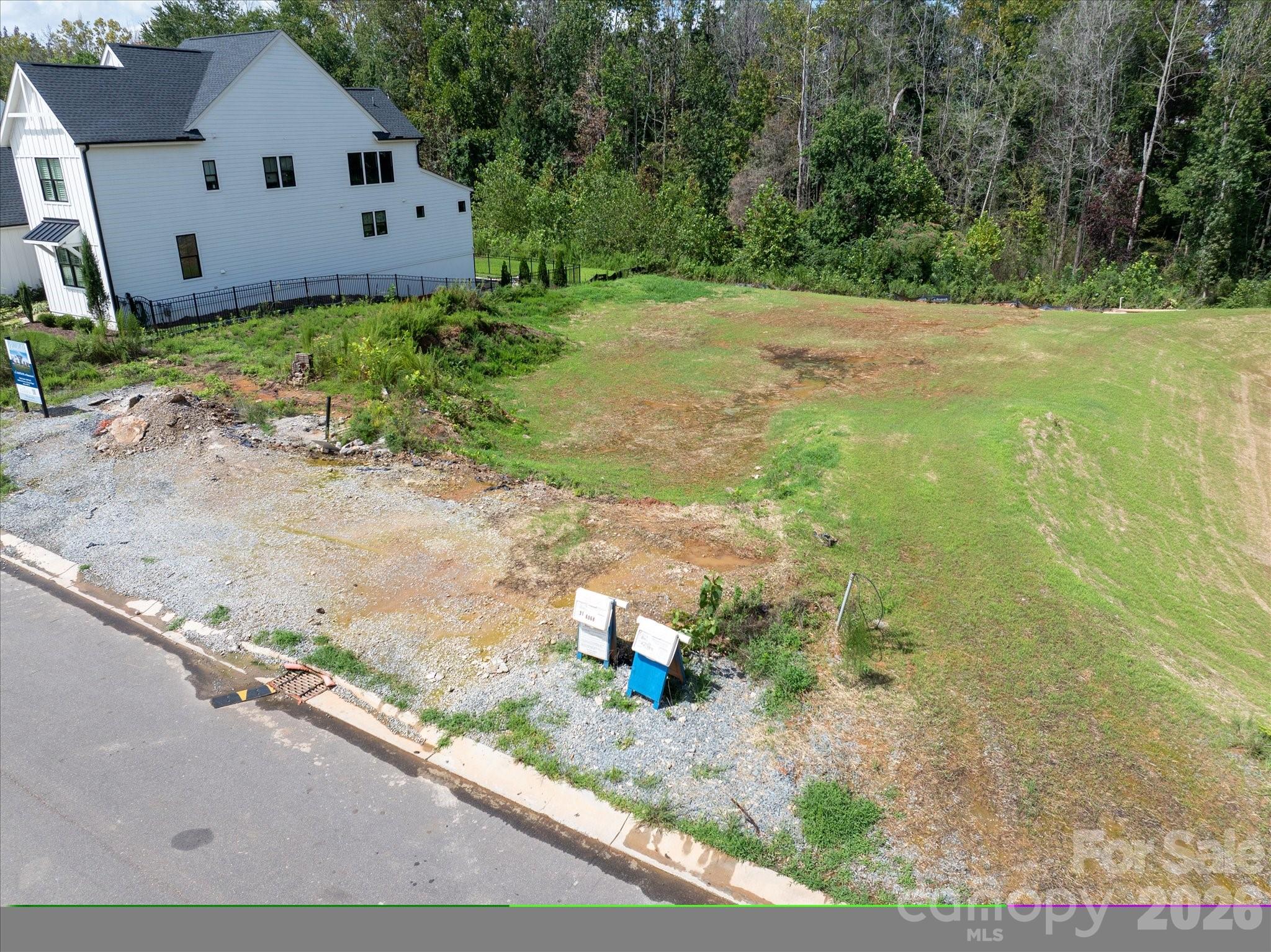 LAST CHANCE!  A rare opportunity to build a brand-new Classica home on the last remaining basement homesite in sought after Arden Mill. This .25-acre wooded homesite backs to a beautiful walking trail with wooded views to the rear.

This is a land sale with a required build agreement with Classica Homes. Buyers select from a curated collection of architect-designed floor plans and personalize their home's finishes, fixtures, and selections through an on-site design studio. Due to the natural grade of this homesite, all builds require a basement floor plan — a tremendous opportunity to maximize living space and take full advantage of the wooded, sloped terrain. Available floor plans range from approximately 5,346 to over 6,600 square feet of heated living area with pricing starting from the upper $1.4M range, including lot.

Conveniently located just minutes from charming Downtown Fort Mill with its local shops and restaurants, nearby Anne Springs Close Greenway, and the Ballantyne area, the neighborhood is easily accessible from both I-77, South Charlotte and uptown Charlotte via I-485. Served by top ranked Fort Mill Schools including Catawba Ridge High,, Banks Trail Middle, and River Trail Elementary

Three car Side-entry garage included. Do not walk the lot without a scheduled appointment. Contact listing agent for available basement floor plans, site plan, and build program details.