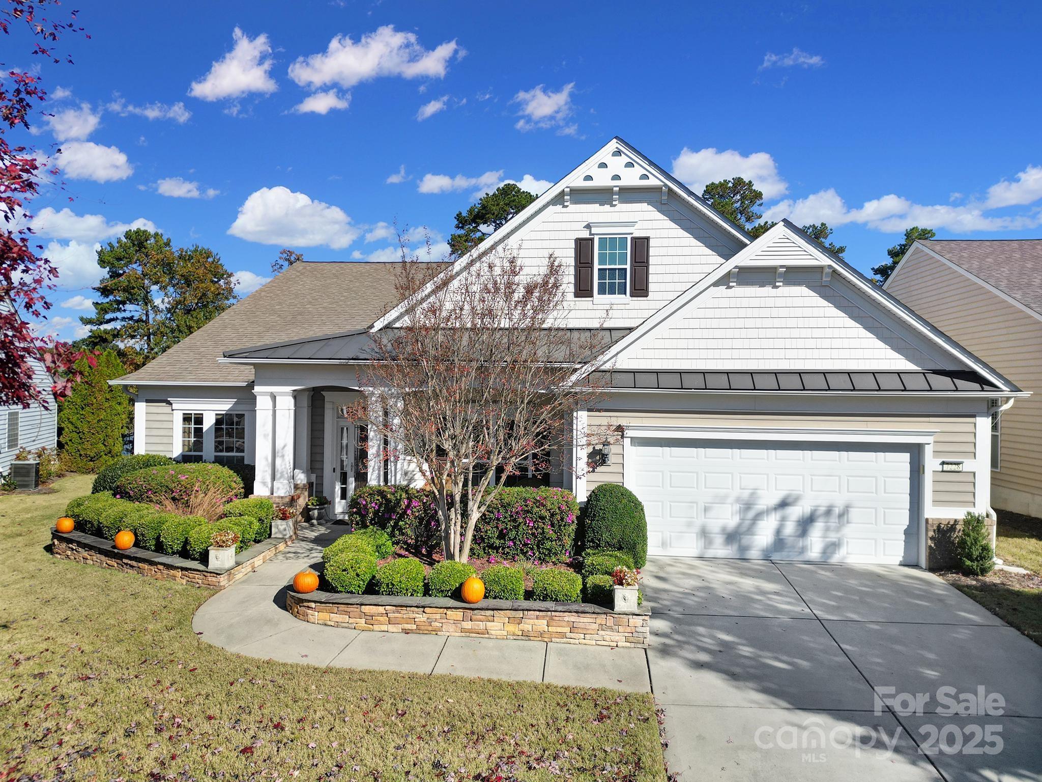 STUNNING Morningside Lane home with extended outdoor entertaining area overlooking the water.  This home is a "must-see" featuring a designer interior loaded with upgrades. A charming covered front porch welcomes you into the grand entryway, flanked by a formal dining room with a chandelier and a den/living room.

The chef's kitchen is a true highlight, offering painted two-toned cabinets to the ceiling, a center island, granite countertops, a gas cooktop with a vented hood, tile backsplash, and stainless-steel appliances. A breakfast bar separates the kitchen from the expansive great room, complete with a cozy gas log fireplace flanked by built-in bookshelves. Stunning archways lead into the sunroom, which boasts oversized windows that flood the space with natural light, providing sweeping views of the back patio and lake.

The spacious primary suite is located at the back of the home for privacy with a tray ceiling and double doors that open up to an updated ensuite bath. The primary bath features an extended dual vanity, luxurious tub, a tiled walk-in shower with glass door, and a his & hers walk-in closet. Two generous secondary bedrooms are located at the front of the home, each offering ample space and access to their own full baths. Make sure to check out the walk-in laundry room with custom shiplap backdrop and built-in cabinets with sink & folding table. 

Step outside and enjoy the outdoors under a romantic custom Tuscan-style pergola and paver patio, offering serene water views that provide the perfect backdrop for relaxation and entertaining.

This home is located within the highly sought-after 55+ Sun City Carolina Lakes golf community known for its resort-style amenities including golf club, indoor & outdoor pools, gym with indoor track, sports courts offering tennis, pickle ball, bocci ball, softball field, canoe/kayak center, dog park, woodworkers shop & miles of walking/biking trails. This community is all about LIFESTYLE and there are over 150 clubs at last count - something for everyone. Convenient location with easy access to restaurants, grocery, banking, shopping, and the Del Webb Public Library. Don't forget the low SC Taxes!