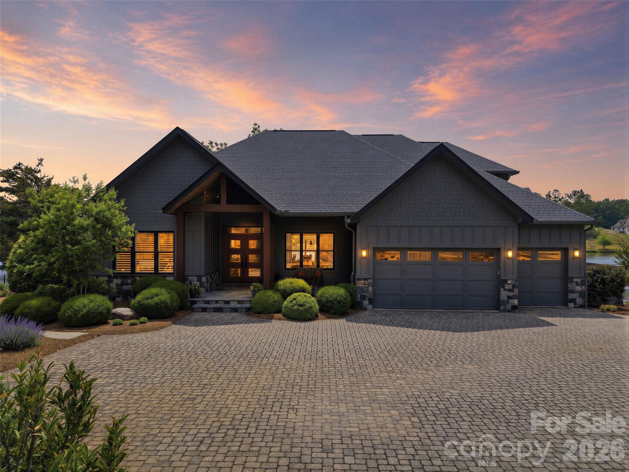 Welcome to Derbyshire—an exclusive gated equestrian community in the heart of Polk County—where luxury living meets the beauty of horse country. Nestled along the community lake, this stunning home on Mapleton Lane offers breathtaking water views from nearly every room, creating a peaceful retreat you’ll never want to leave. This property sits on just over 1 acre with the option of purchasing the adjoining lot for additional privacy or future investment. With over 3,000 square feet of thoughtfully designed living space, the home features soaring ceilings, expansive windows with window treatments, and abundant natural light throughout the living, kitchen, and dining areas—all perfectly positioned to capture the serene lake views. The well-appointed kitchen is equipped with premium appliances and features a charming built-in breakfast area, creating the perfect spot to enjoy your morning coffee while overlooking the water. Wake up to lake views from every bedroom and unwind each evening with sunsets reflecting across the water. A dedicated office with custom built-ins provides an ideal work-from-home space, while the spacious layout also includes a versatile bonus room perfect for a media room, guest retreat, hobby space, or additional office. The primary suite offers a true retreat experience with a spa-like bathroom featuring a large soaking tub, an expansive walk-in shower adorned with beautiful marble tile, and elegant finishes throughout, creating a luxurious space to relax and recharge. The oversized 2.5-car garage offers functionality rarely found in residential homes. In addition to ample room for vehicles and storage, it includes a secondary laundry area designed for larger items such as horse blankets, along with a utility sink and built-in cabinetry providing exceptional storage and workspace. Quality craftsmanship and thoughtful upgrades can be found throughout the home, including the added peace of mind of a whole-home Generac generator, ensuring comfort and convenience year-round. Residents of Derbyshire enjoy access to outstanding equestrian amenities, including a community barn, riding arena, and boarding opportunities, making it easy to embrace the horse-country lifestyle. Located just minutes from Tryon International Equestrian Center, this home places you in the heart of one of the Southeast’s premier equestrian destinations. Whether you’re drawn to Derbyshire for its equestrian lifestyle, scenic beauty, luxury amenities, or sense of privacy, this rare lakefront opportunity offers it all from your own private retreat.