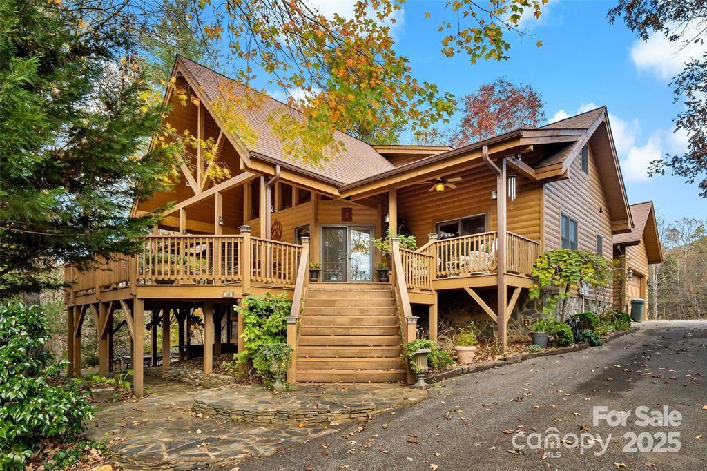 1 HOUSE and 1 OFFICE Bldg on approx 11.5 ACRES.
The house has a beautiful open design (2,683 sq ft) with log siding and rock exterior. The main floor has a great room, kitchen, dining area, sunroom, laundry room, 2 bedrooms and 2.5 baths. The upper floor features a loft and studio room which is currently being used as a spare bedroom. A finished basement under part of the house is perfect for an office/workout room. A detached garage is connected to the house by a covered breezeway. A new roof was just installed in July 25' and a new Heat Pump.  The freshly painted, covered front porch is the perfect place to host gatherings! The office building, 900 sq ft, is ready for a variety of applications. It includes a lobby area, a receptionist space, a small lab area, 5 offices and 2 restrooms.
Much of the property is fenced, and there is a run-in shed/storage barn that is perfect for horses/goats. Included are several fruit trees and a large blueberry patch with over 200 bushes. There is over 360 ft of boundary with the US Forest Service. A 20 minute hike out the back gate leads to the ‘Mountains to Sea Trail’. This is a breathtaking property!  The neighboring property is for sale - 65 Gypsy Mountain Drive, MLS number 4353949.